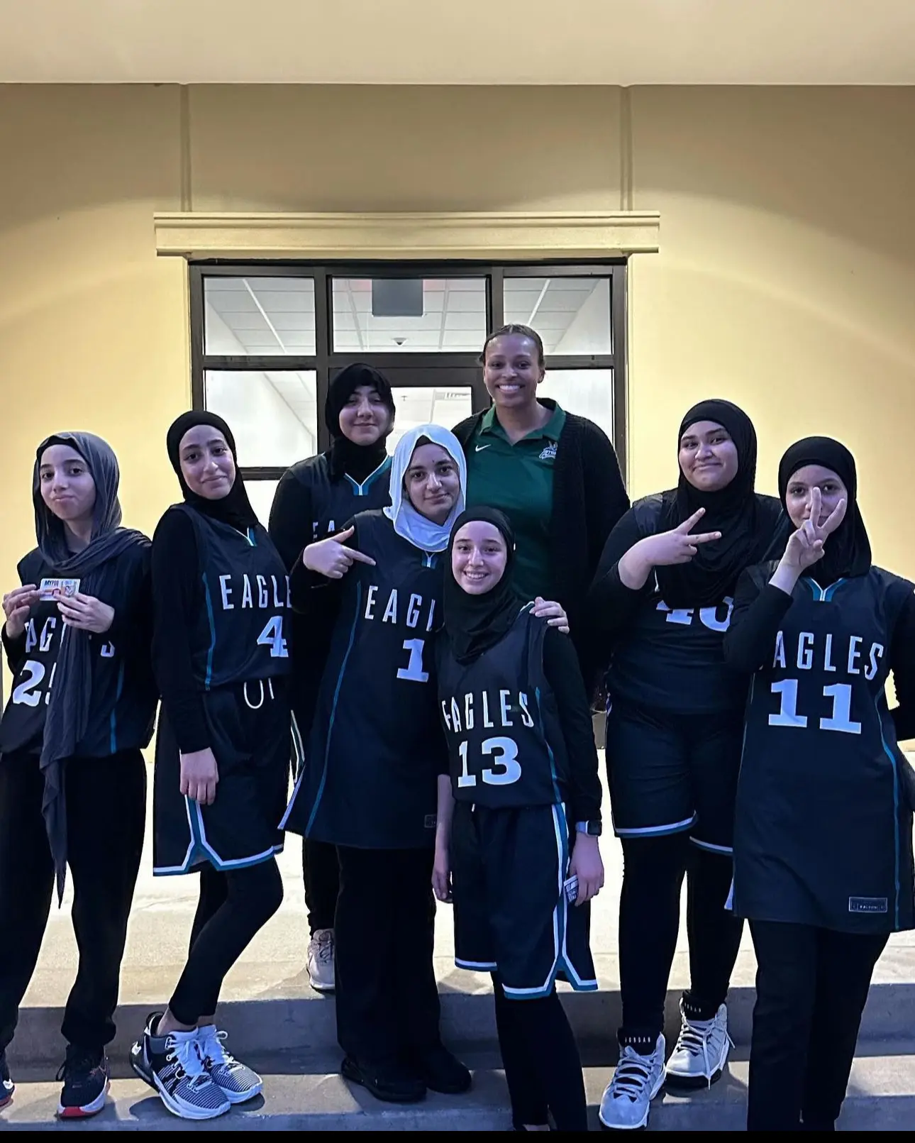 Girls and women basketball players wearing hijabs together