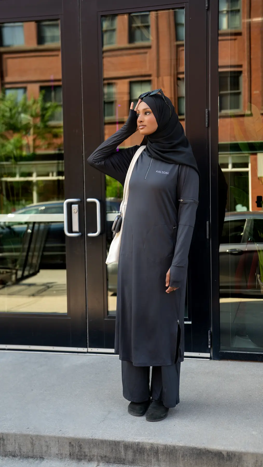 Woman wearing a full-length black Kalsoni tunic in the city