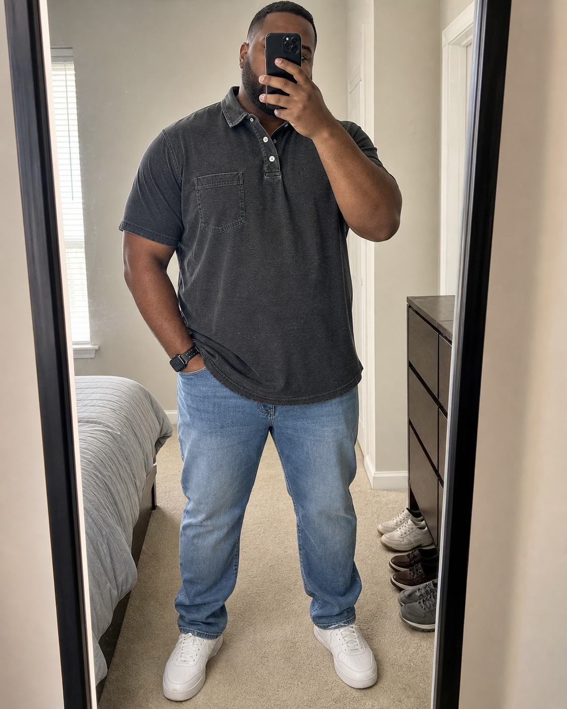 AI style inspiration mirror fit wearing a Washed Black pocket polo in a bedroom