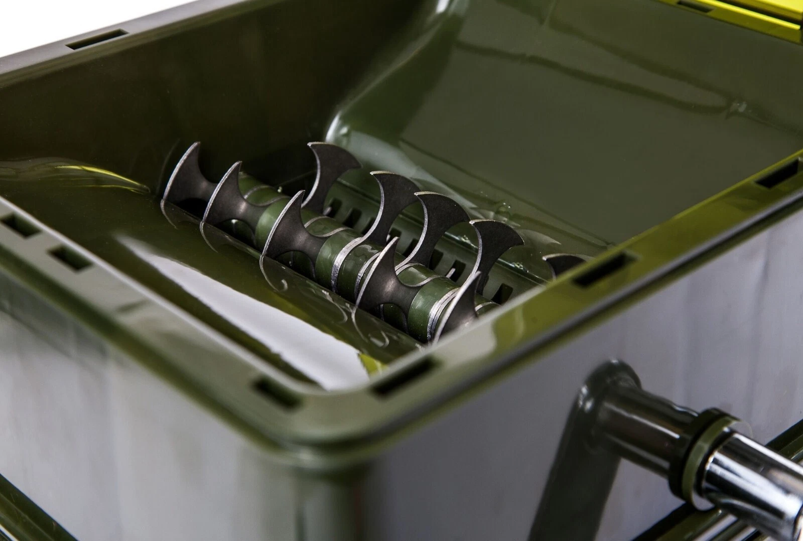 Stainless steel auger blades inside the crusher trough