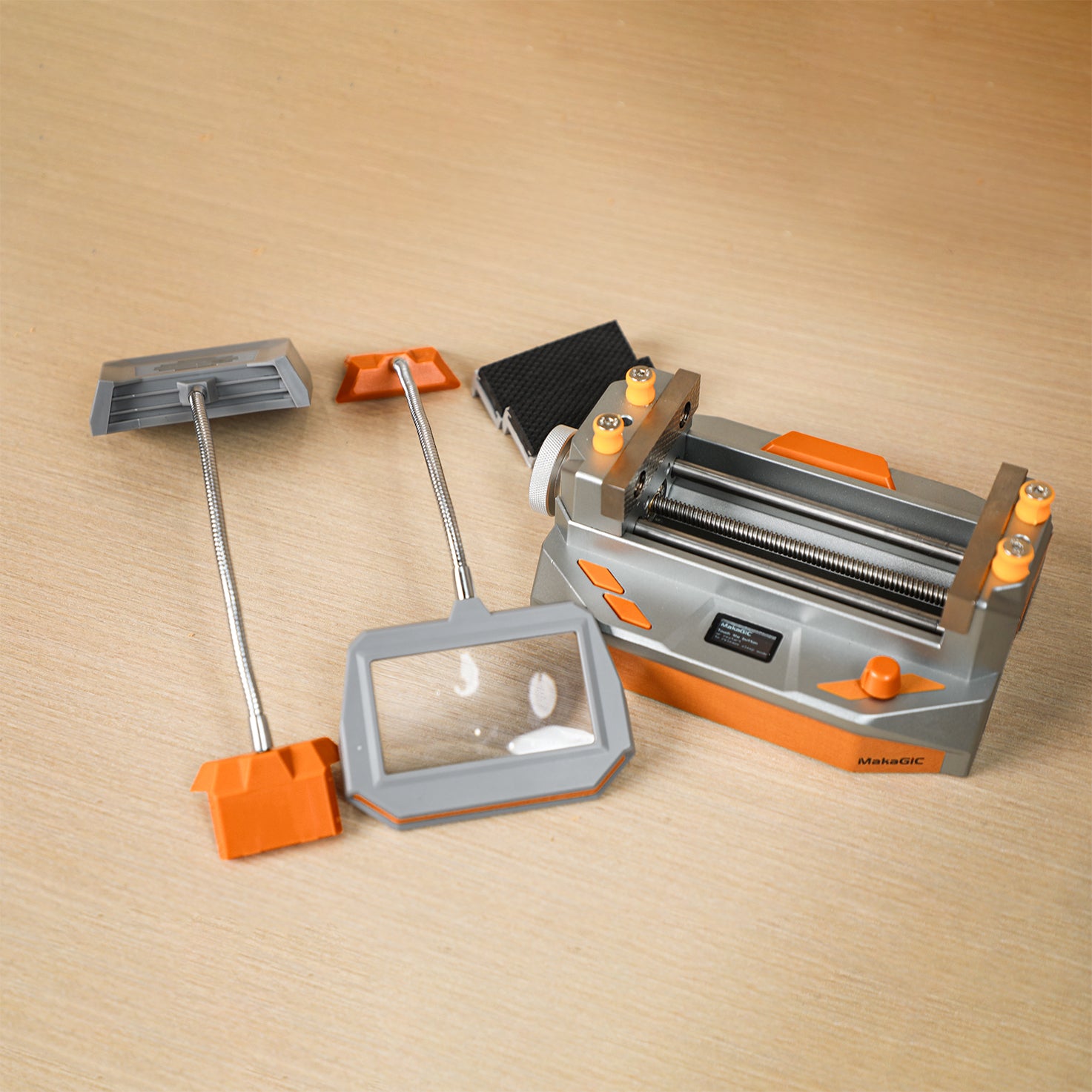 MakaGIC VS01 smart electric vise on a wooden workbench with its magnetic accessories