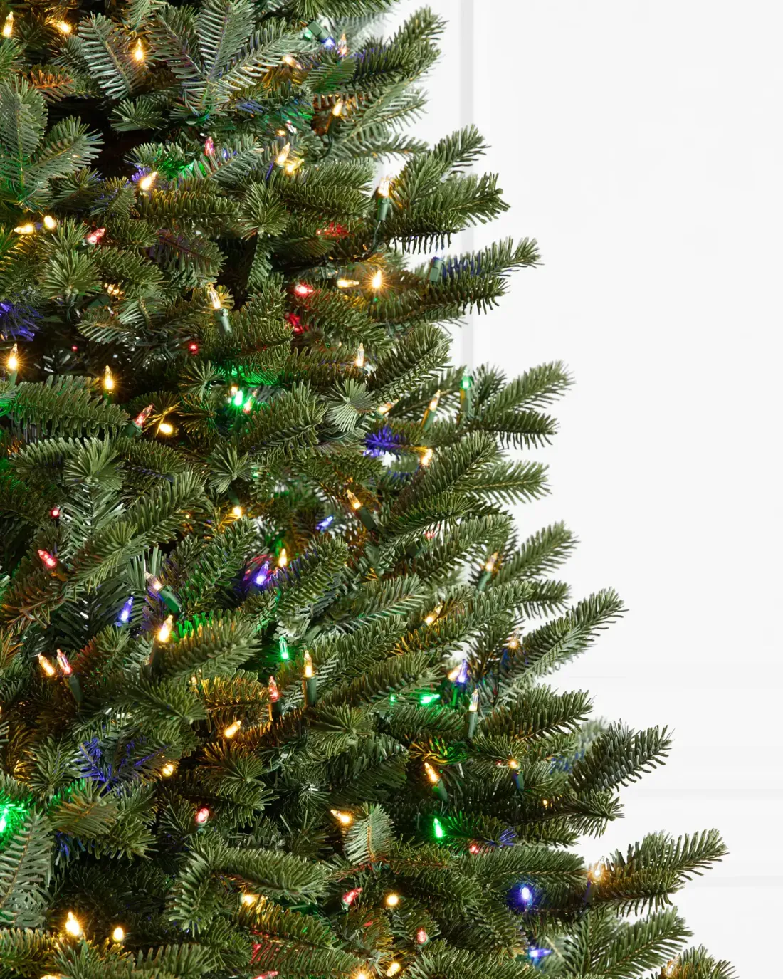 Built-in Christmas lights among green tree branches