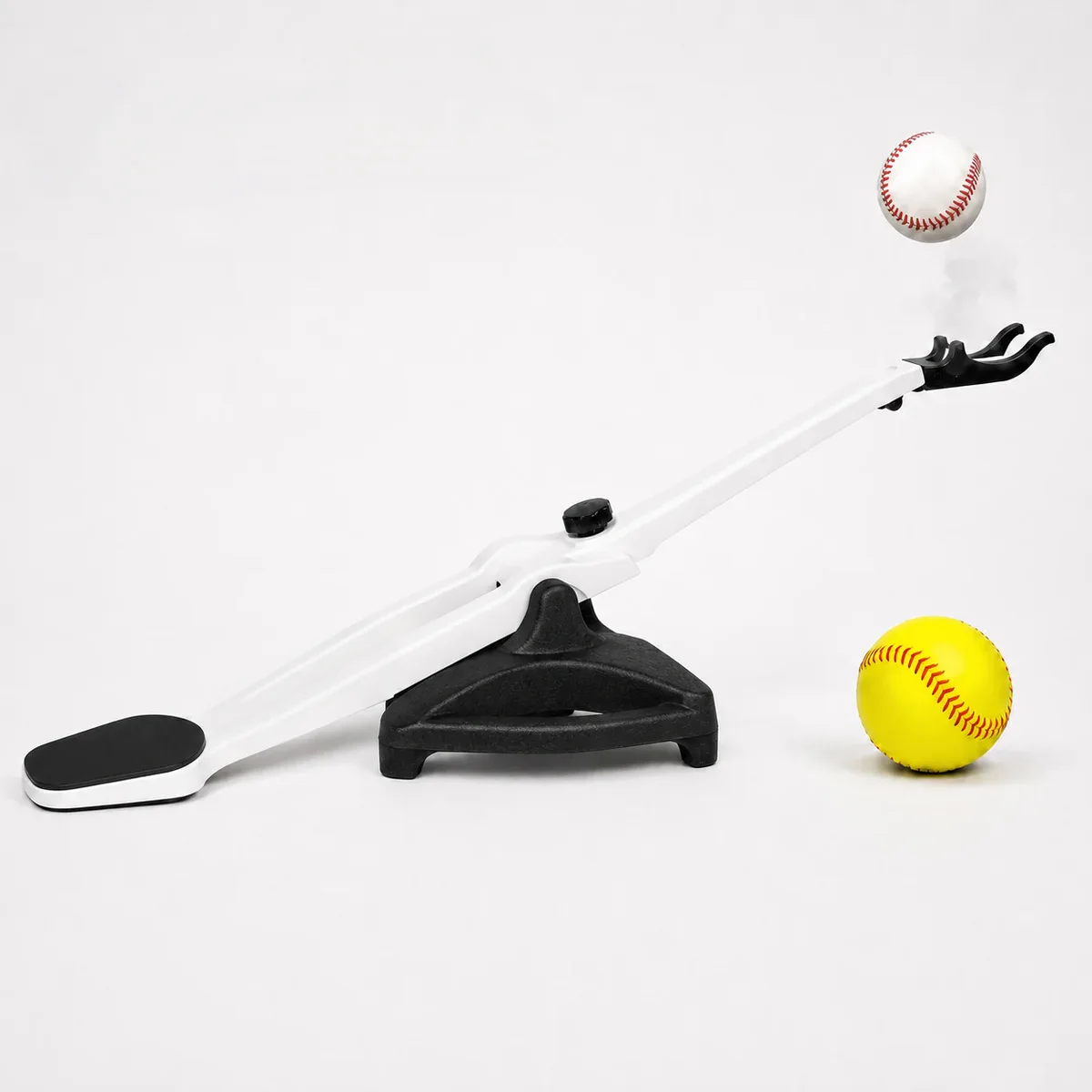Foot-activated soft-toss trainer for independent baseball and softball practice