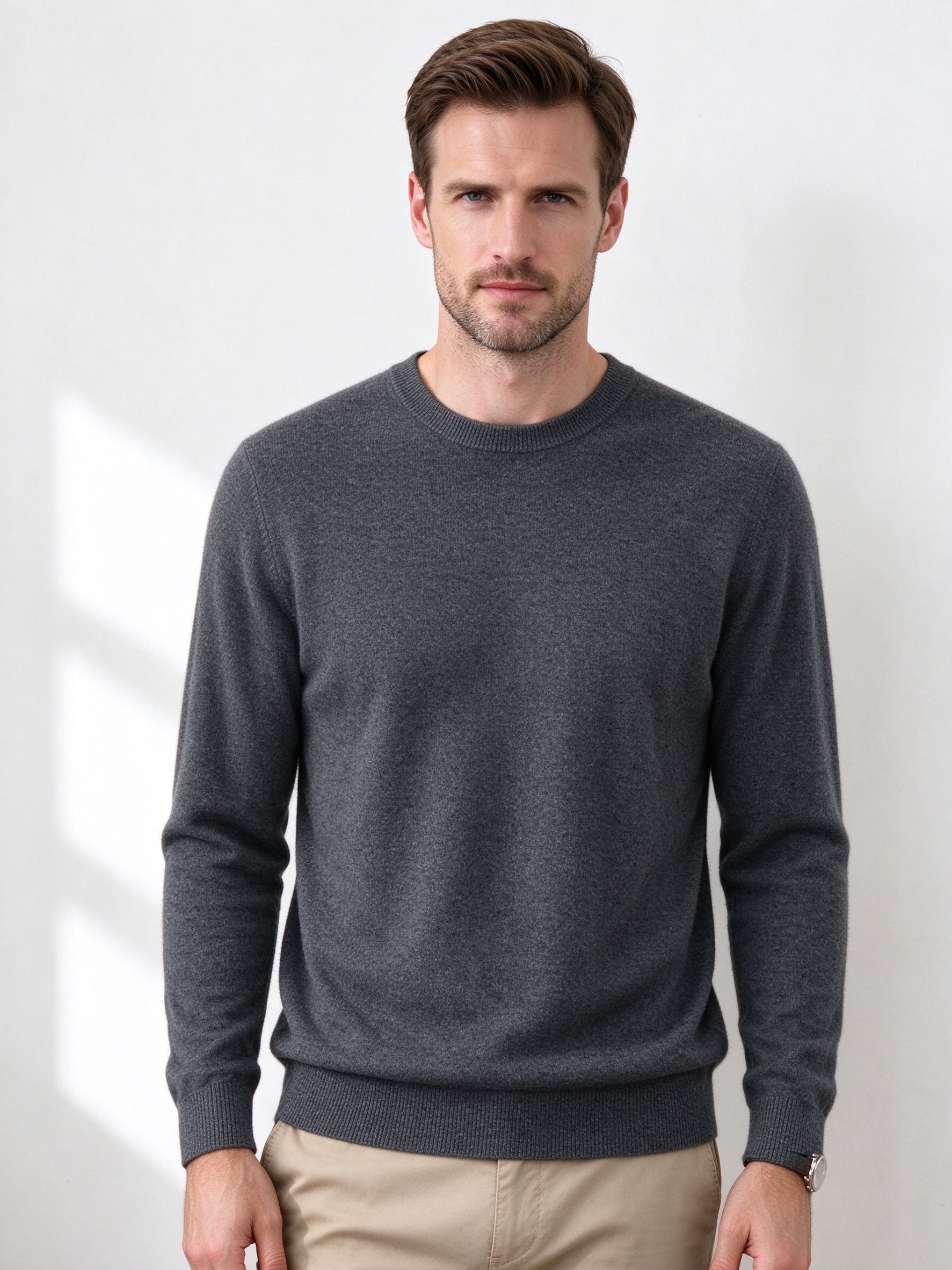Man wearing charcoal crewneck sweater with khaki pants