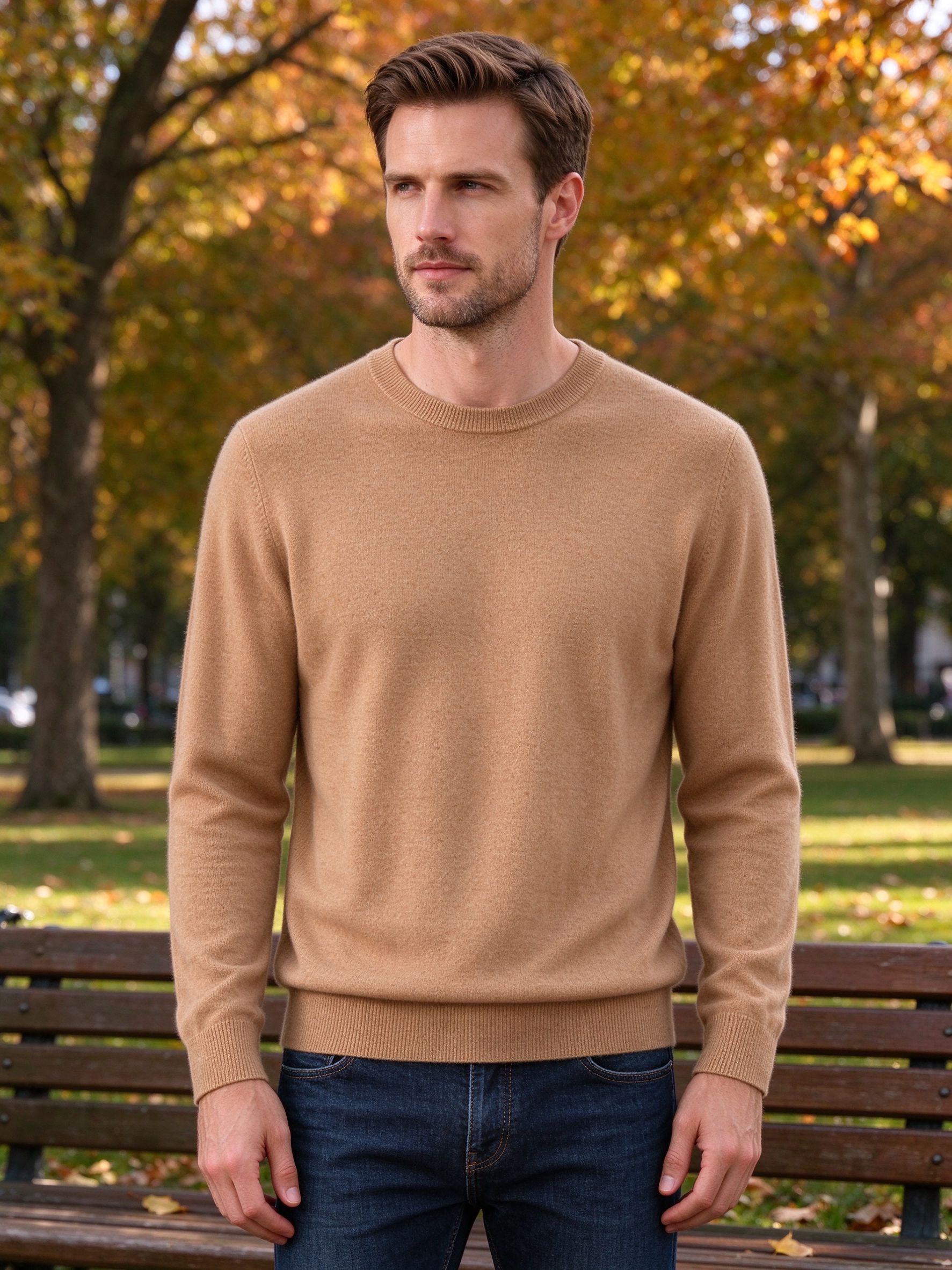Man wearing camel crewneck sweater in autumn park