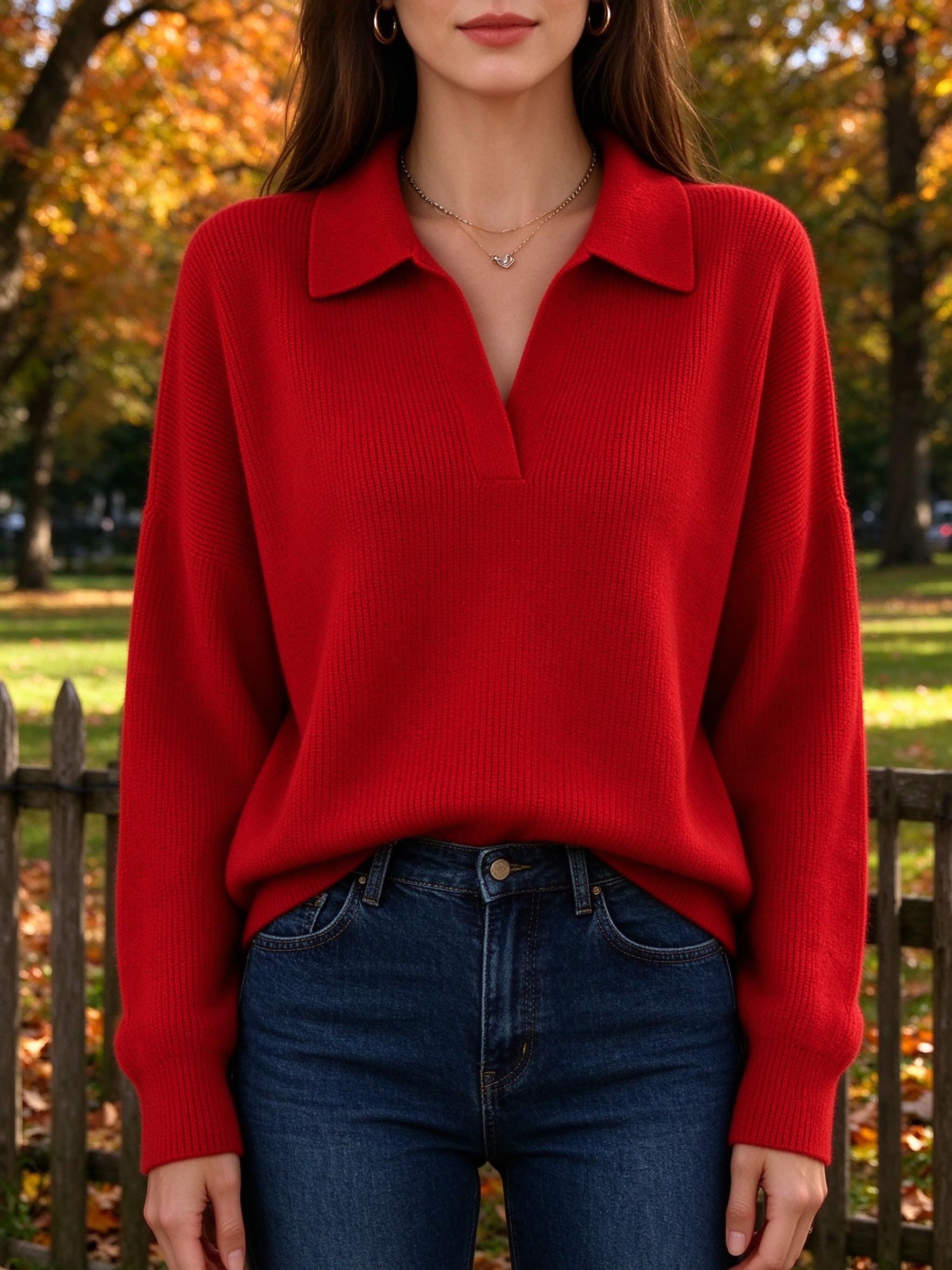 bold red ribbed polo sweater with dark jeans in autumn park
