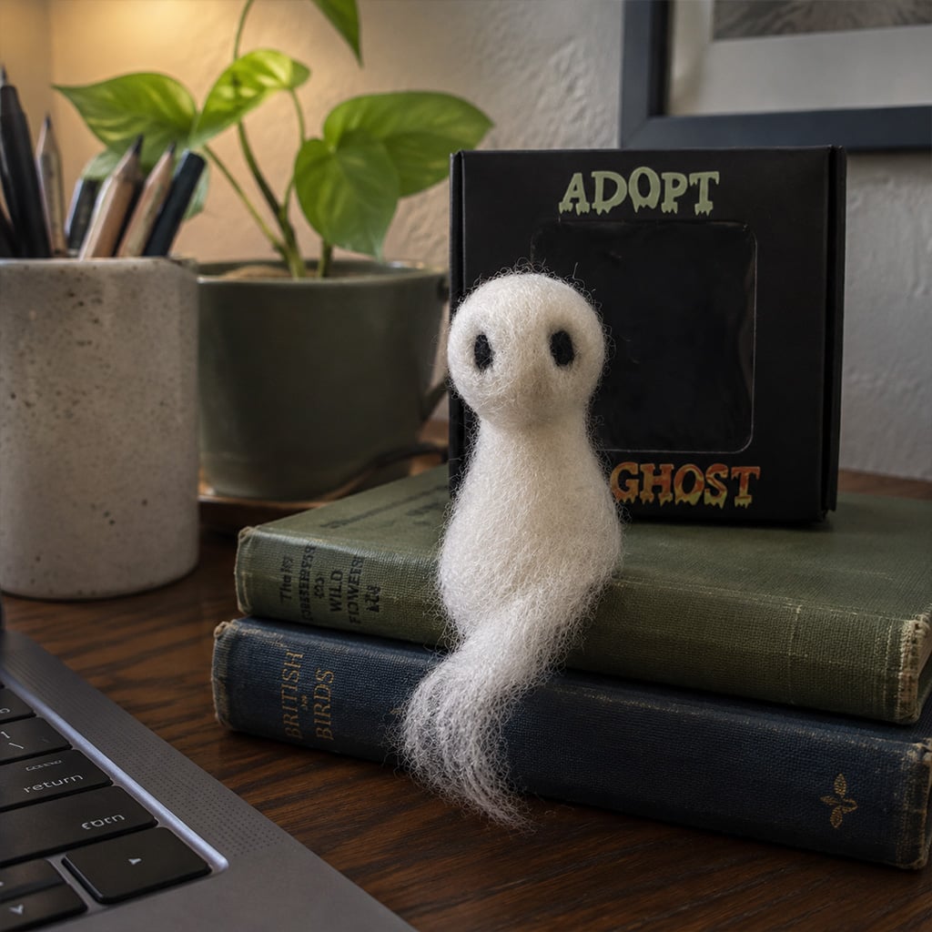 Tiny ghost displayed beside a laptop