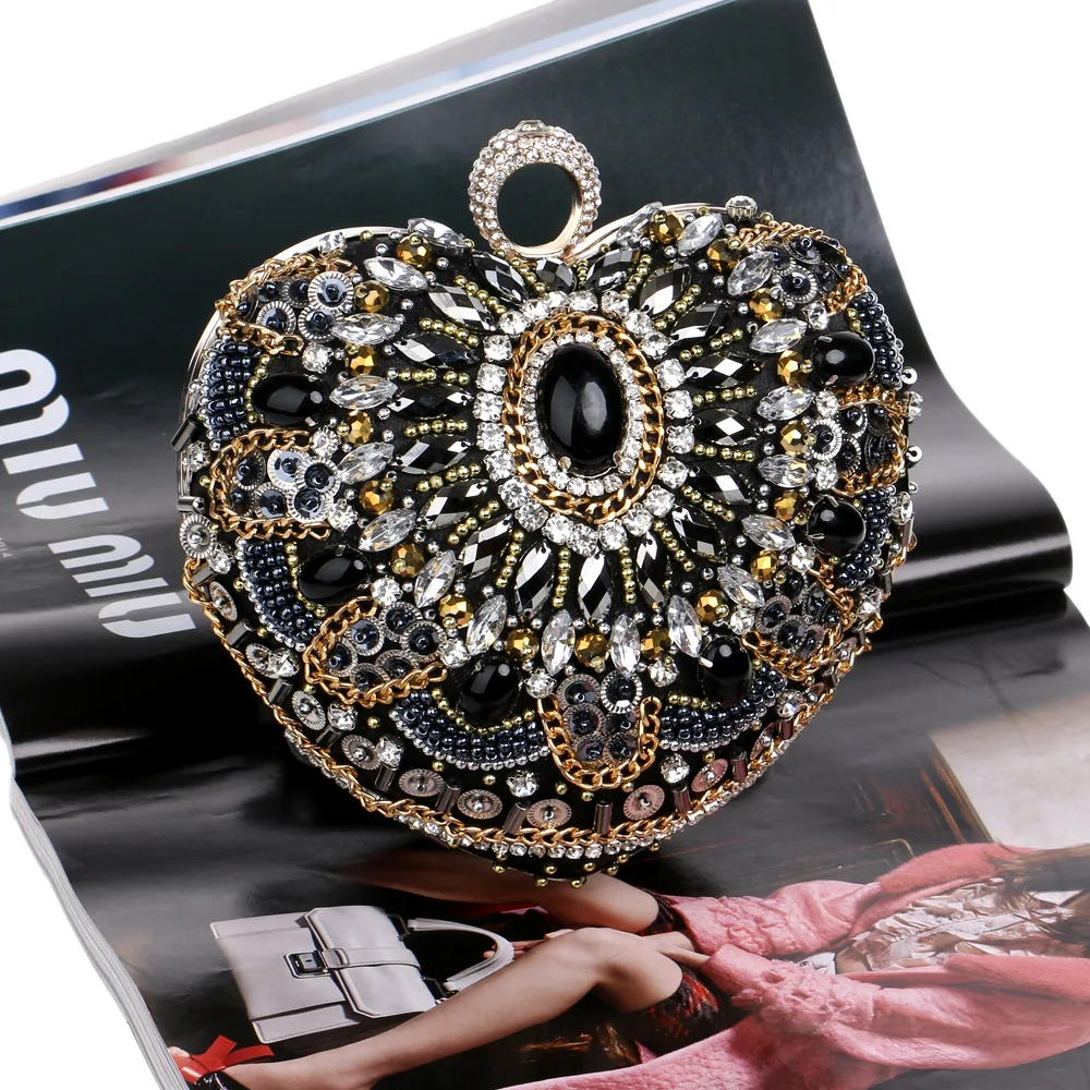 YNSSK Black Clutch Bag with Gold Chain Front View on Book