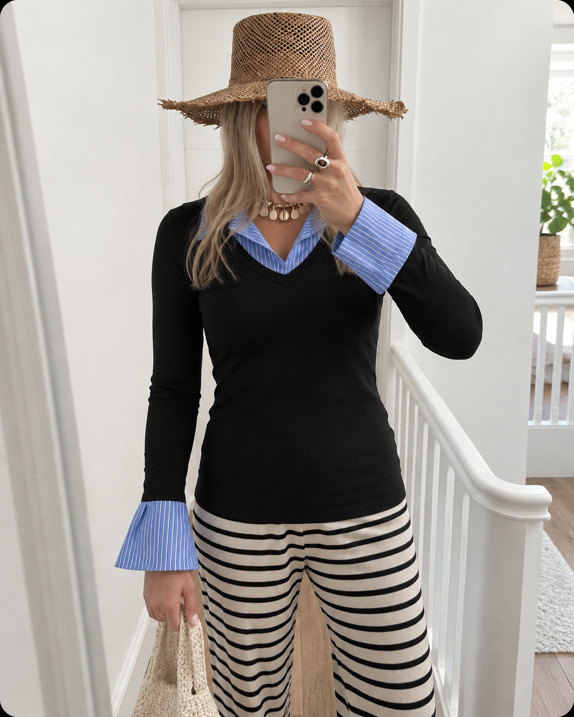 Black top styled with striped pants