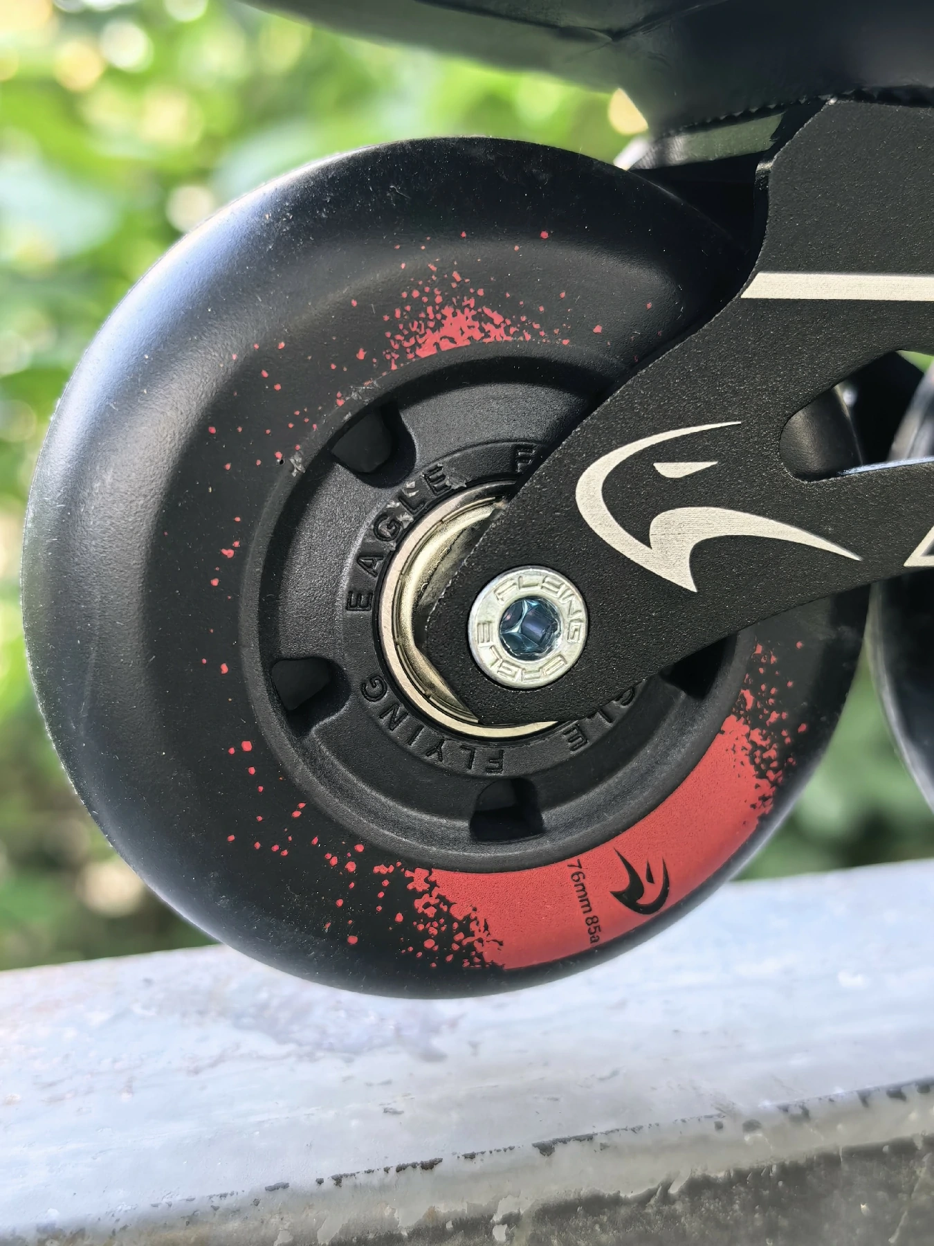 Close-up of a Flying Eagle inline skate wheel, axle bolt and frame