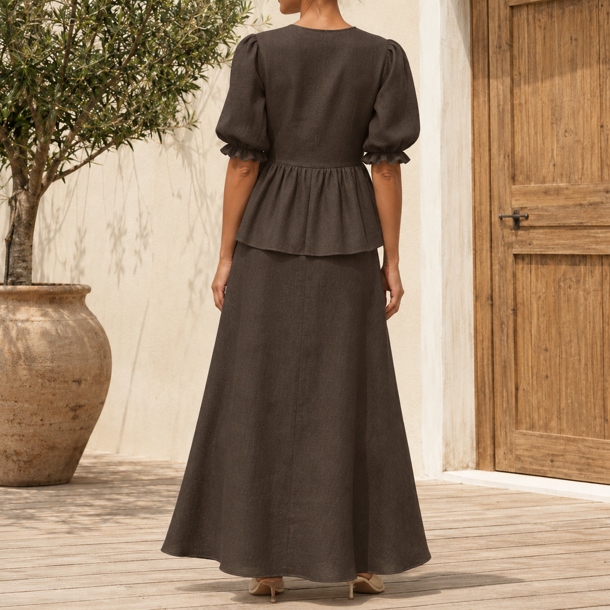 Back view of mocha brown tie front puff sleeve top and maxi skirt