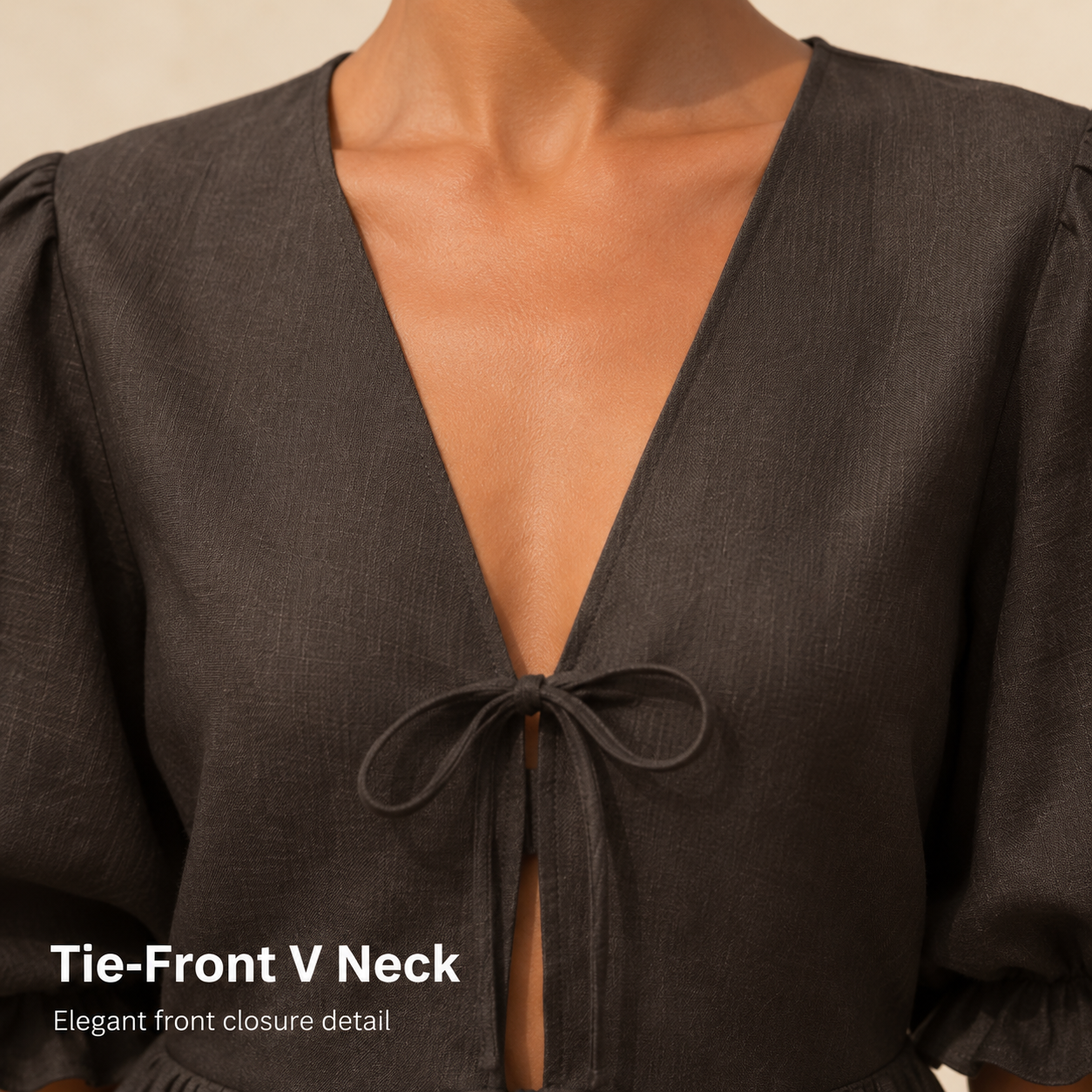 Close view of tie front V neck closure on textured woven top