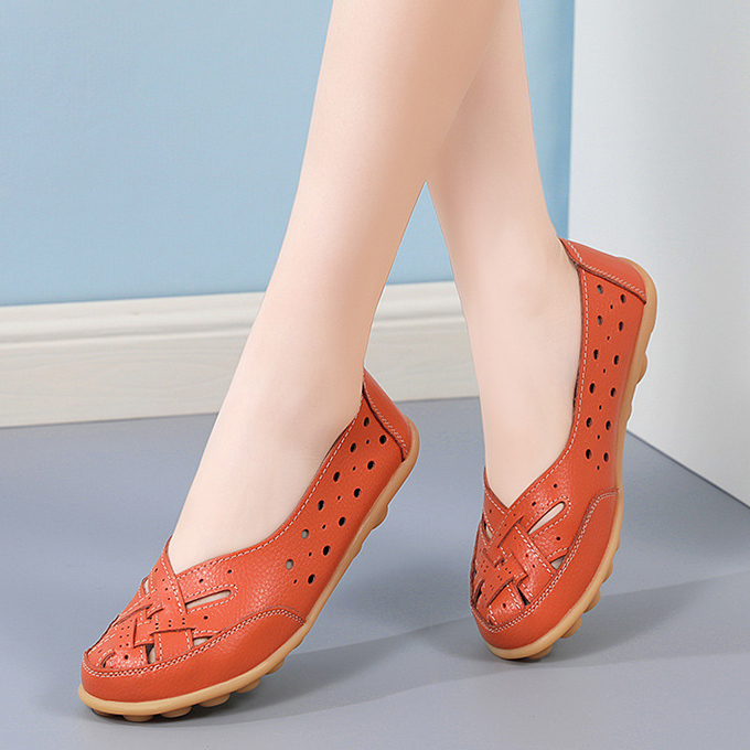 Orange casual slip-on flats styled indoors
