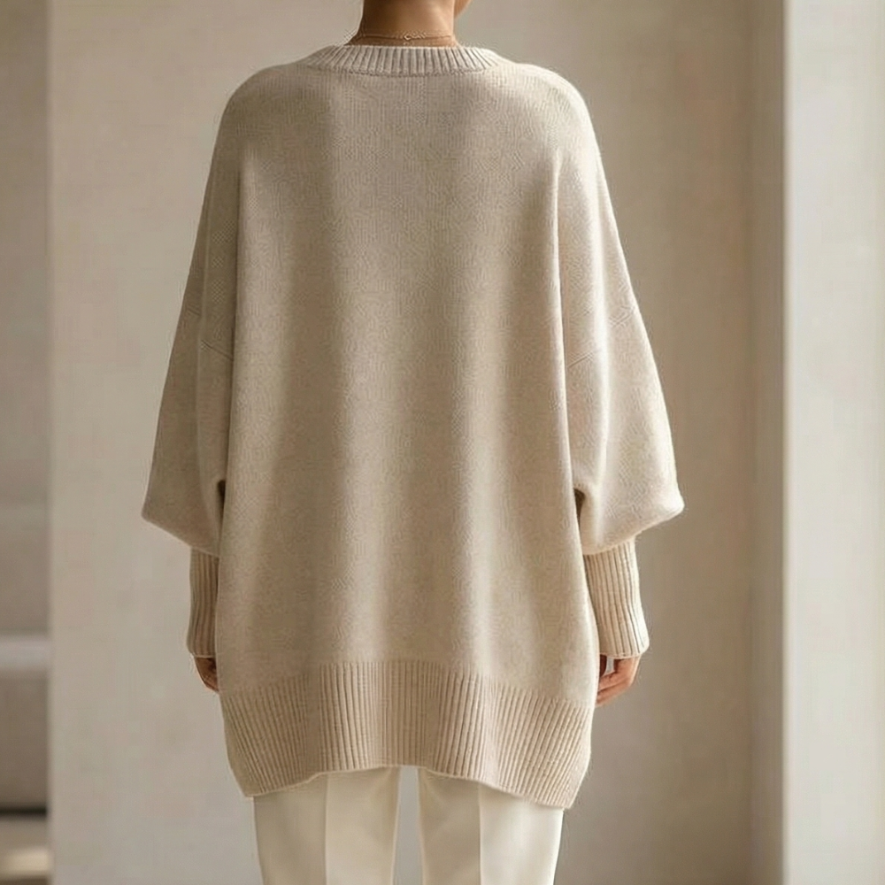 Back view of the oversized sweater showing the loose body, dropped sleeves and ribbed hem
