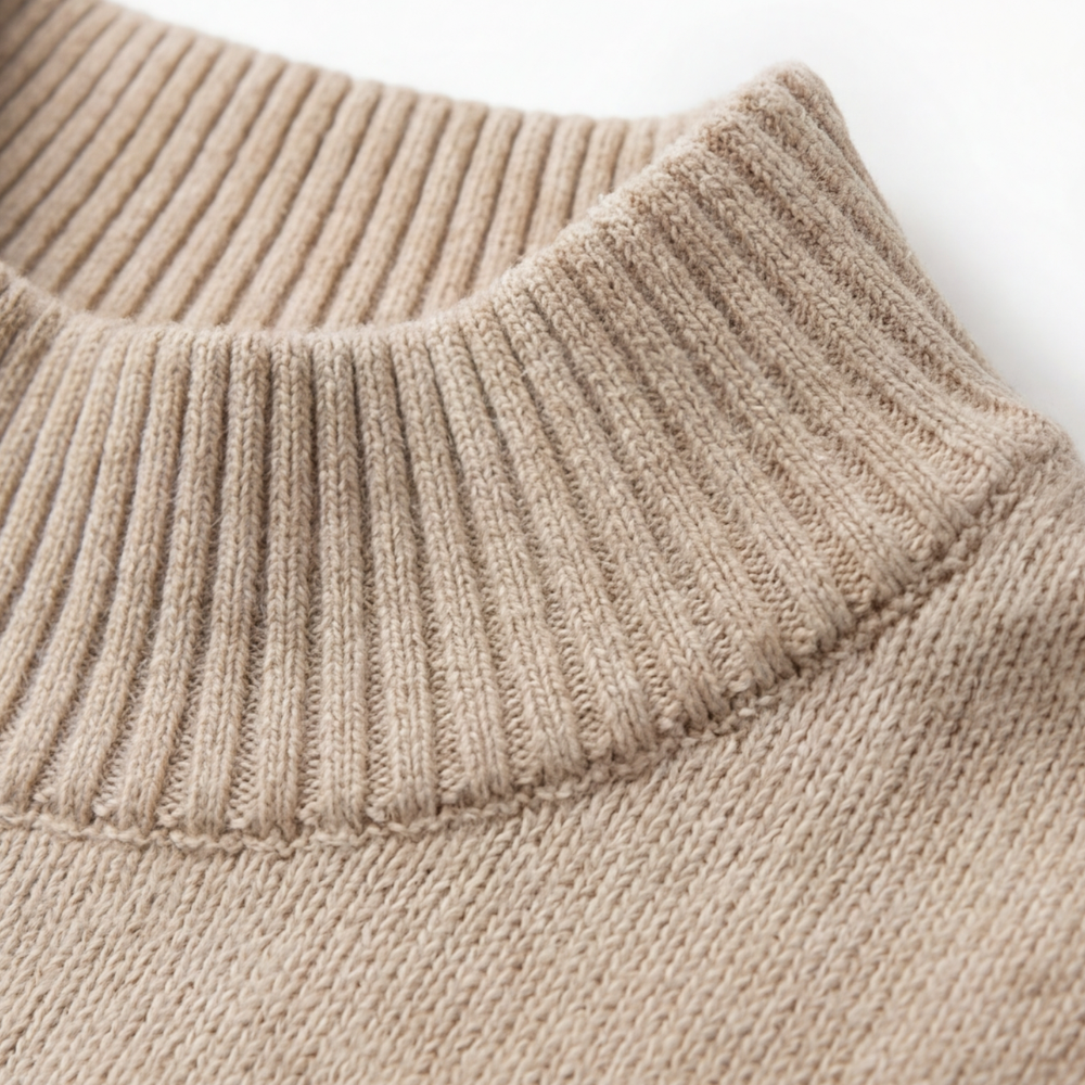 Close-up of the sweater's ribbed high mock neckline and knit construction