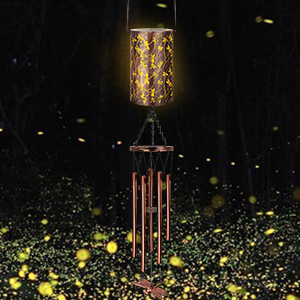 Illuminated cylindrical lamp with decorative metallic pattern, suspended above copper-colored wind chimes against a dark background with glowing particles.