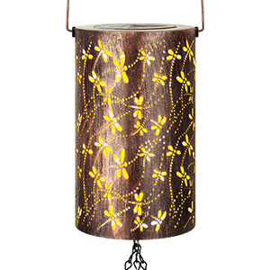 Cylindrical lantern with dragonfly cutout design. Brown metal exterior with yellow light shining through holes, creating a glowing effect. Hanging chain attached.