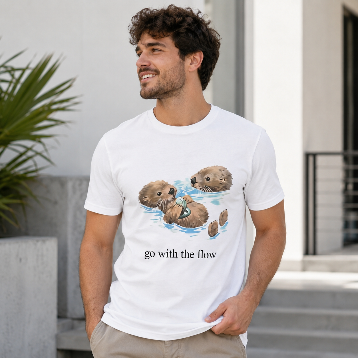 Playful Sea Otter Floating Graphic T-Shirt with Wildlife Illustration and “Go With The Flow” Nature Streetwear Casual Tee