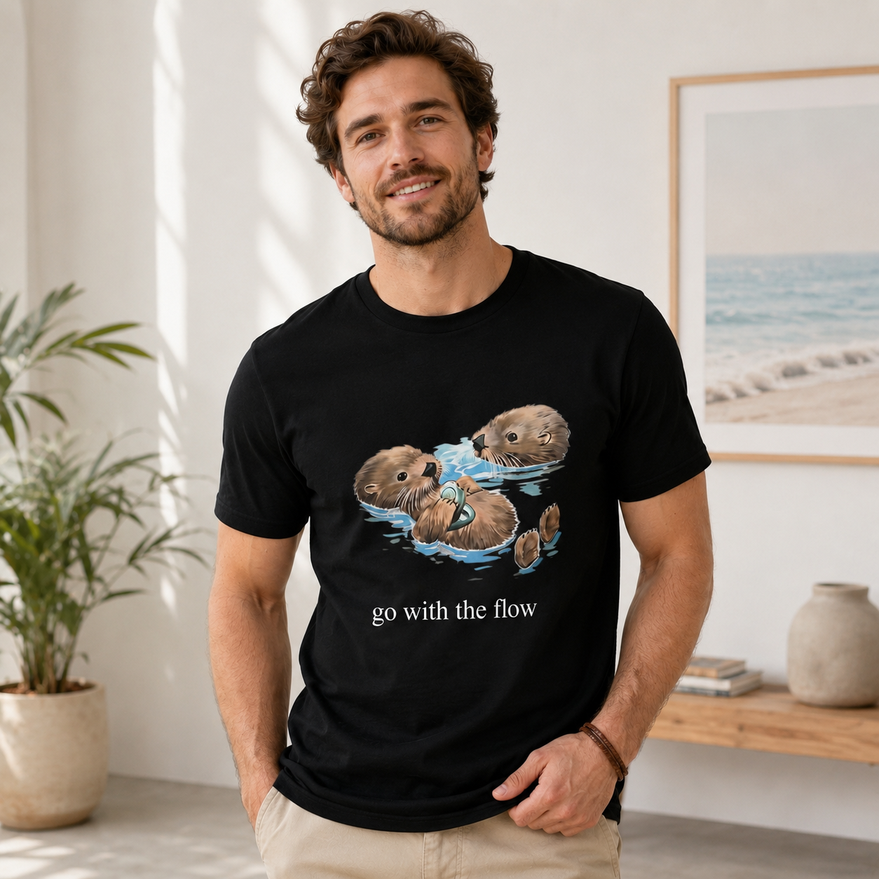 Playful Sea Otter Floating Graphic T-Shirt with Wildlife Illustration and “Go With The Flow” Nature Streetwear Casual Tee