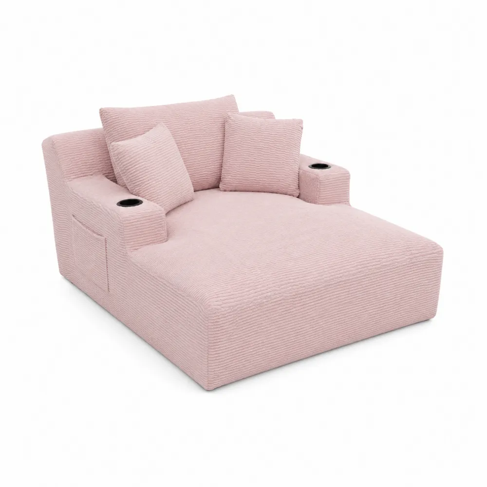 Różowa sofa sztruksowa z uchwytami na napoje i poduszkami