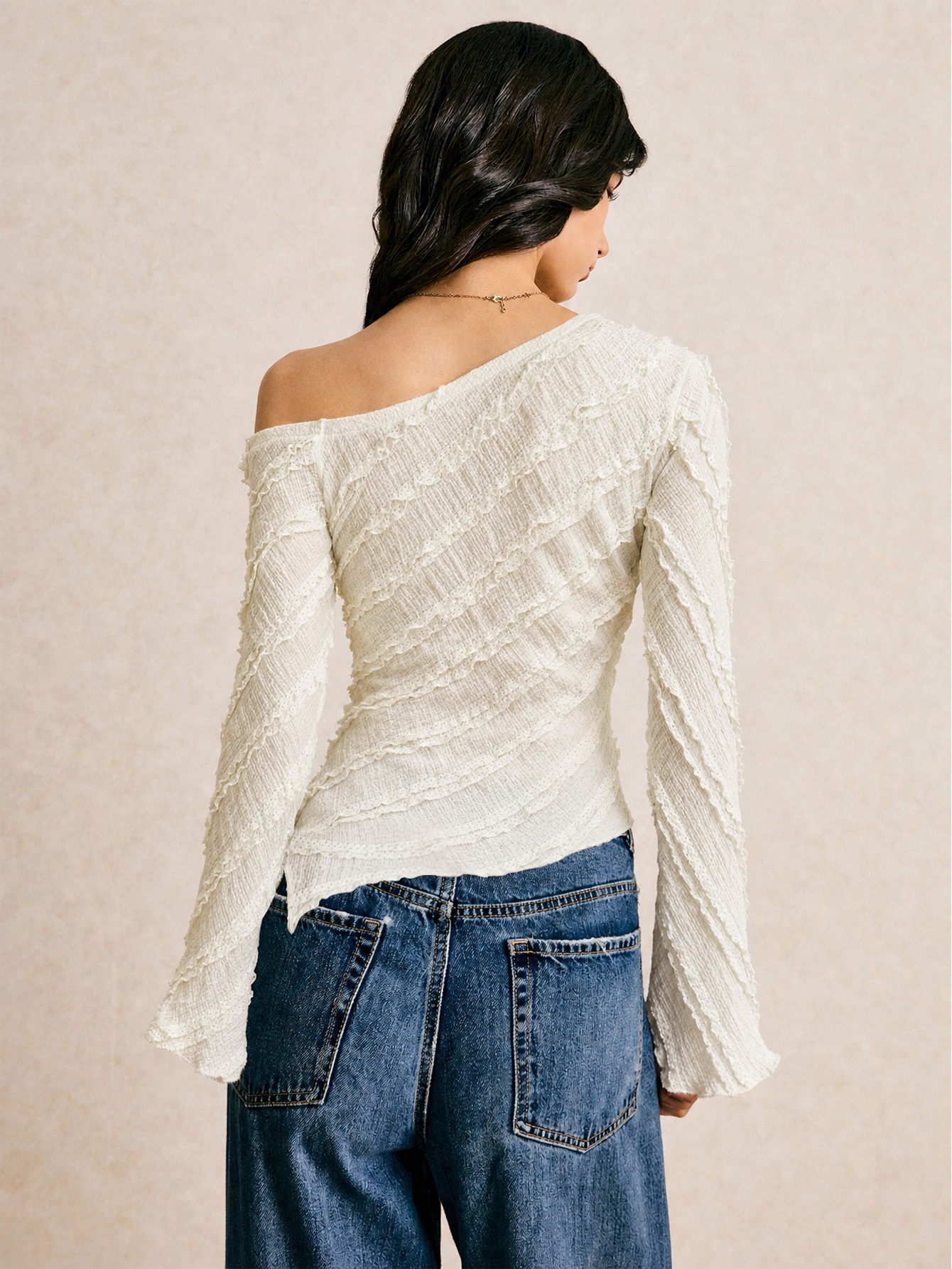 French textured one-shoulder long-sleeve top with asymmetrical hem