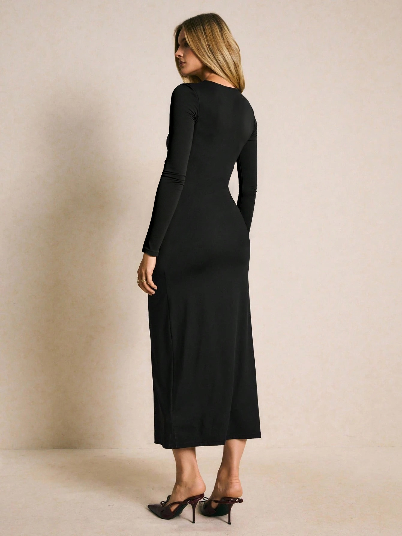 Retro long-sleeve dress with metal buttons, cinched waist, and side slit