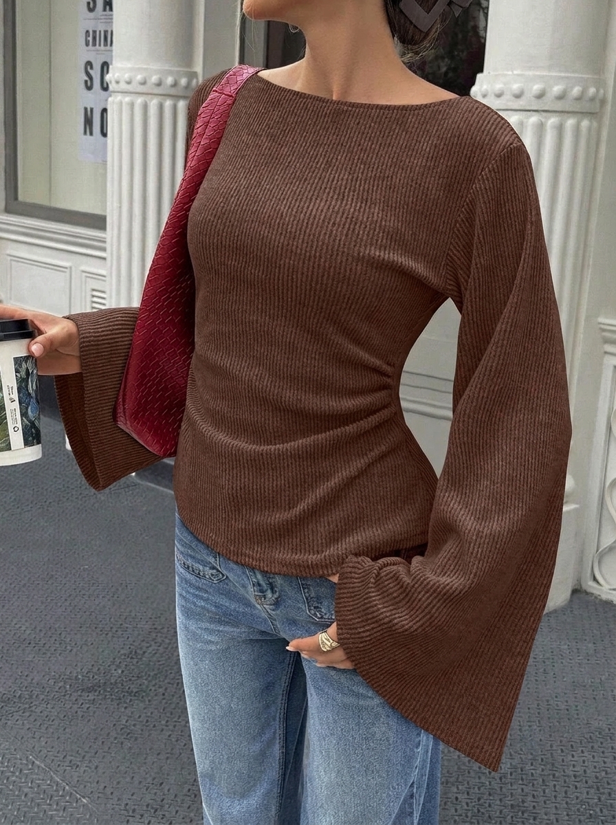 Solid color flared long-sleeve top with off-shoulder neckline and cinched waist