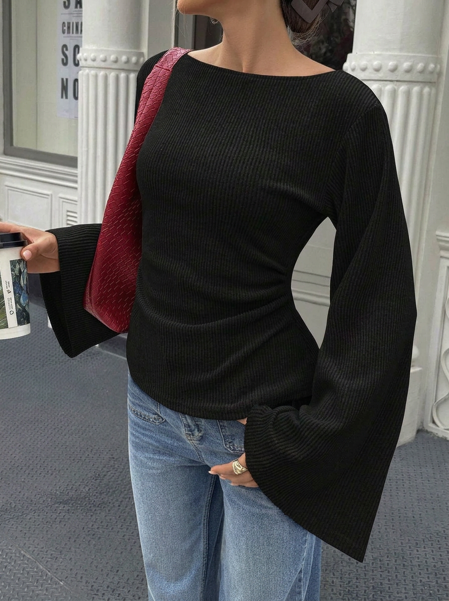 Solid color flared long-sleeve top with off-shoulder neckline and cinched waist