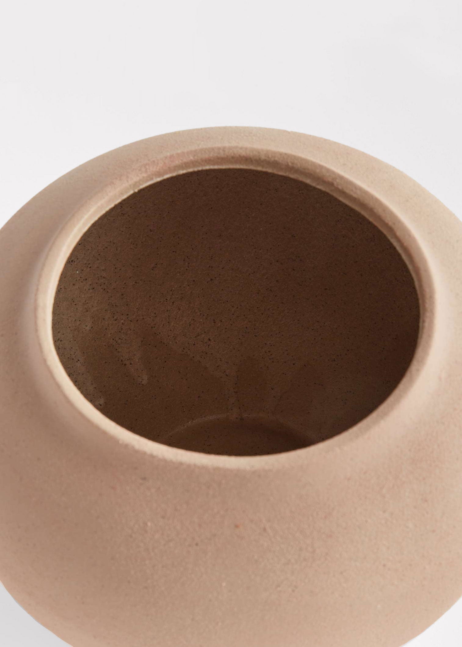 Inside of tan stoneware vase