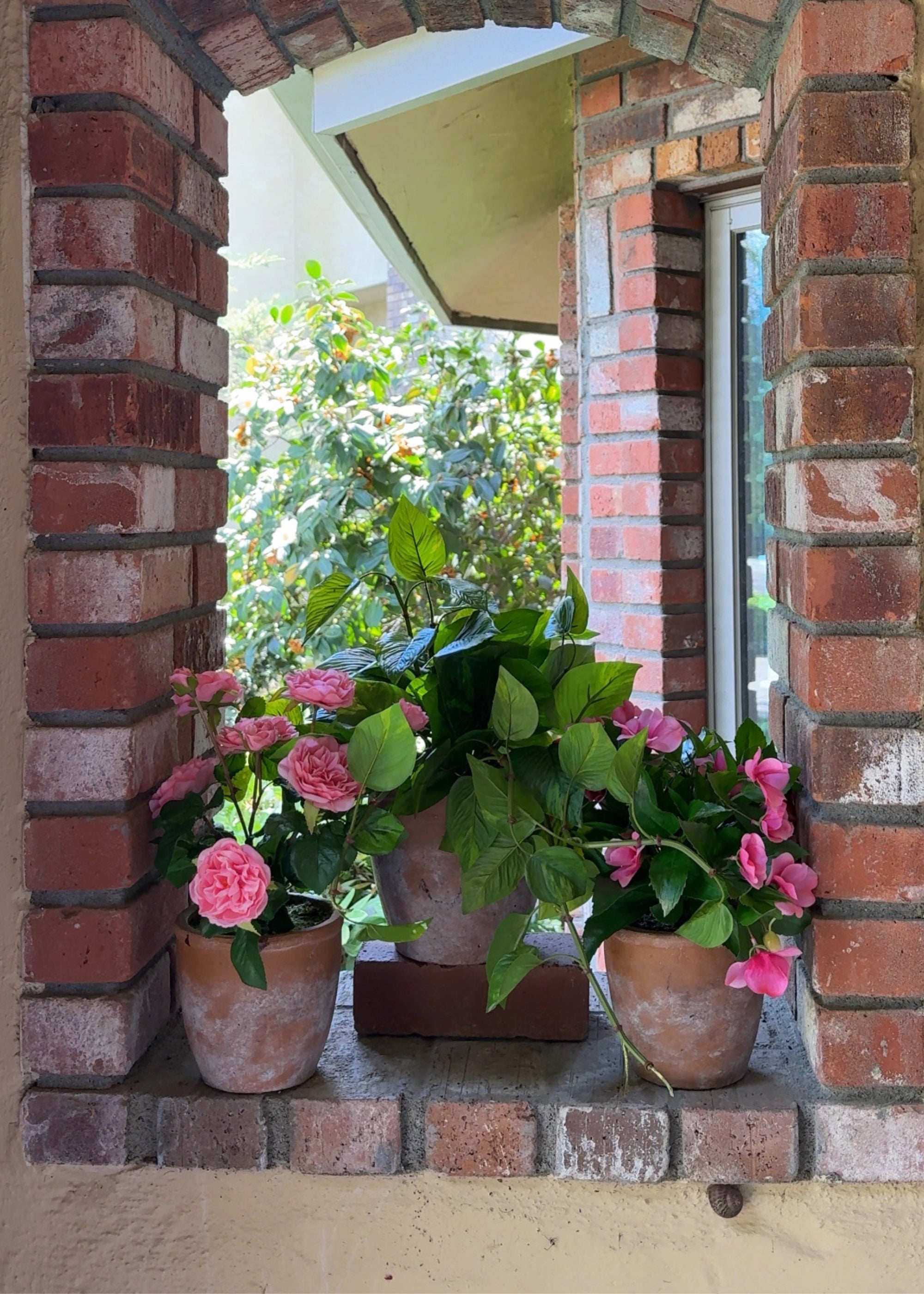 Three potted outdoor artificial plants