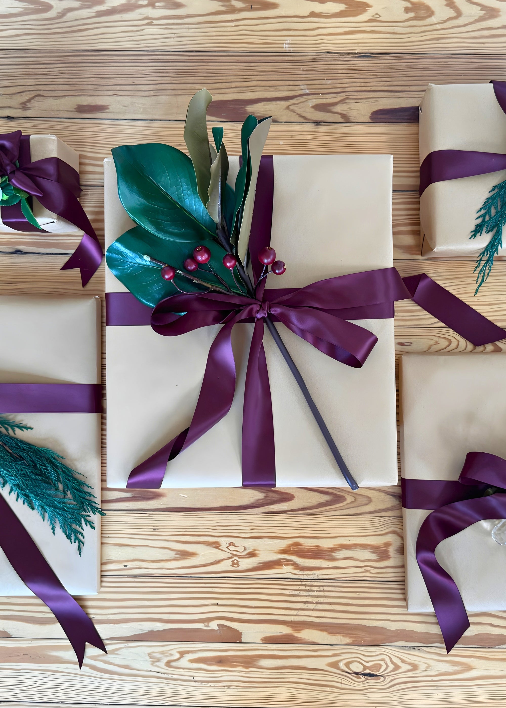 Gifts wrapped and decorated with greenery