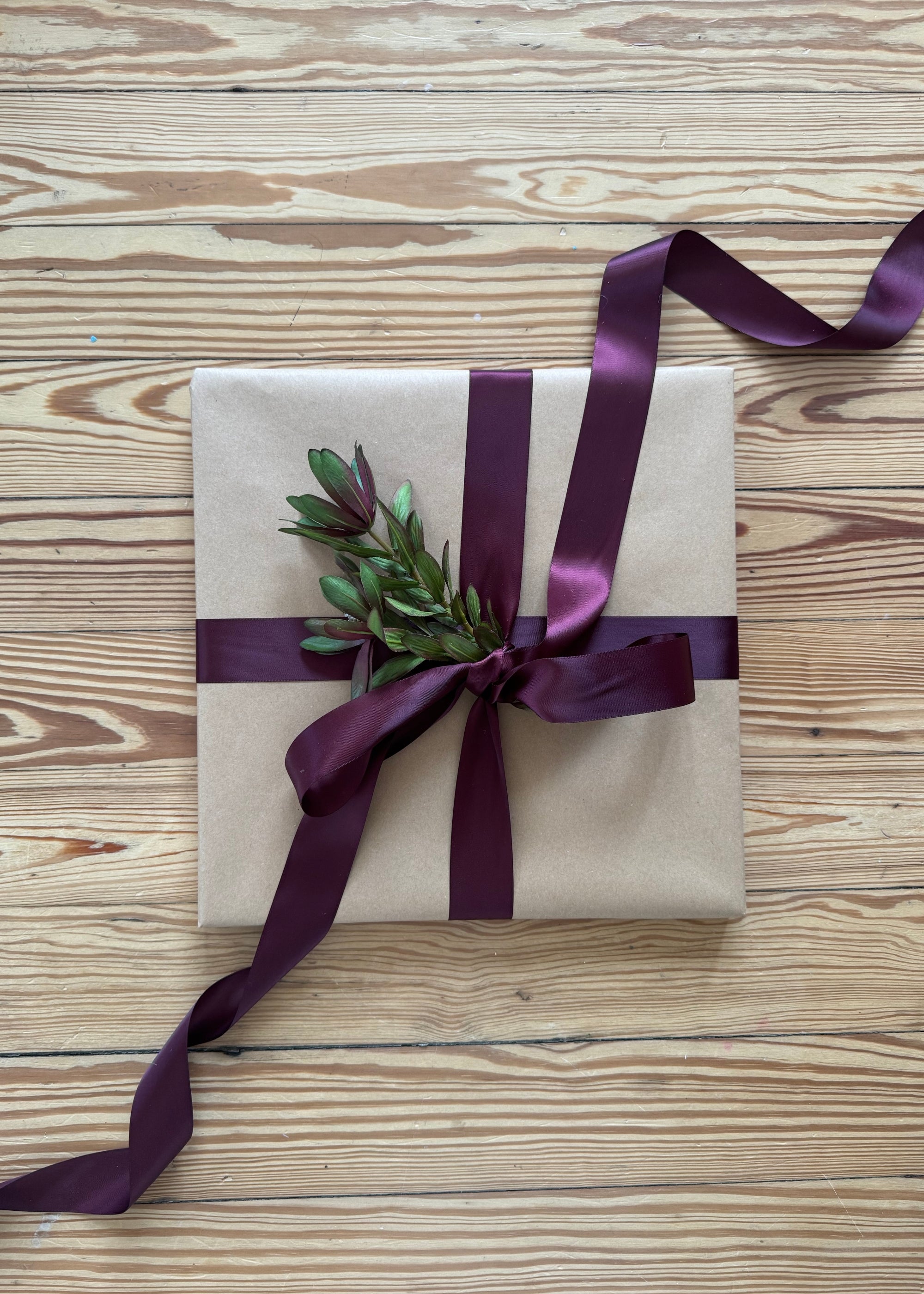 gift wrapped and decorated with artificial protea greenery