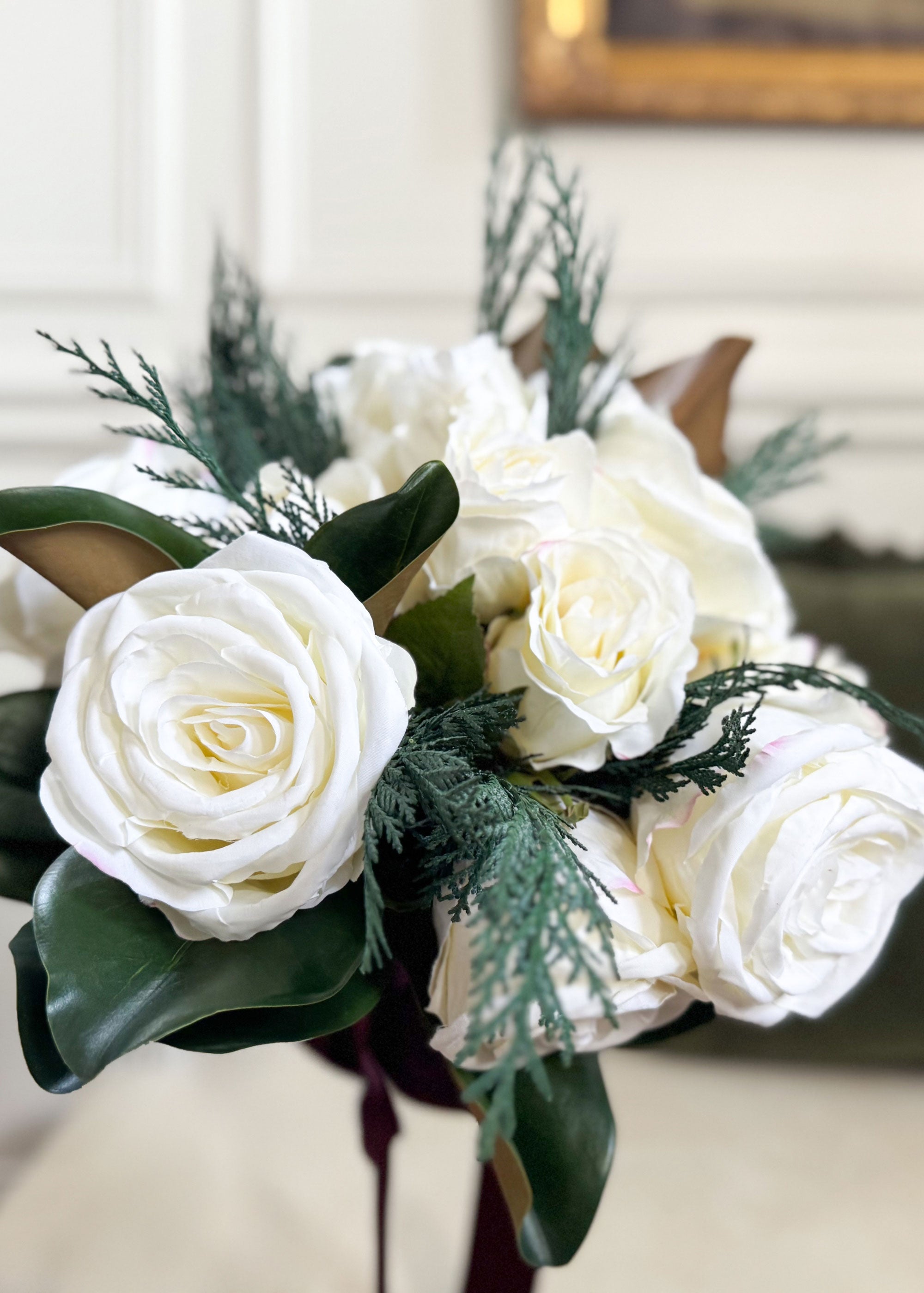 Bouquet of white roses with cedar greenery