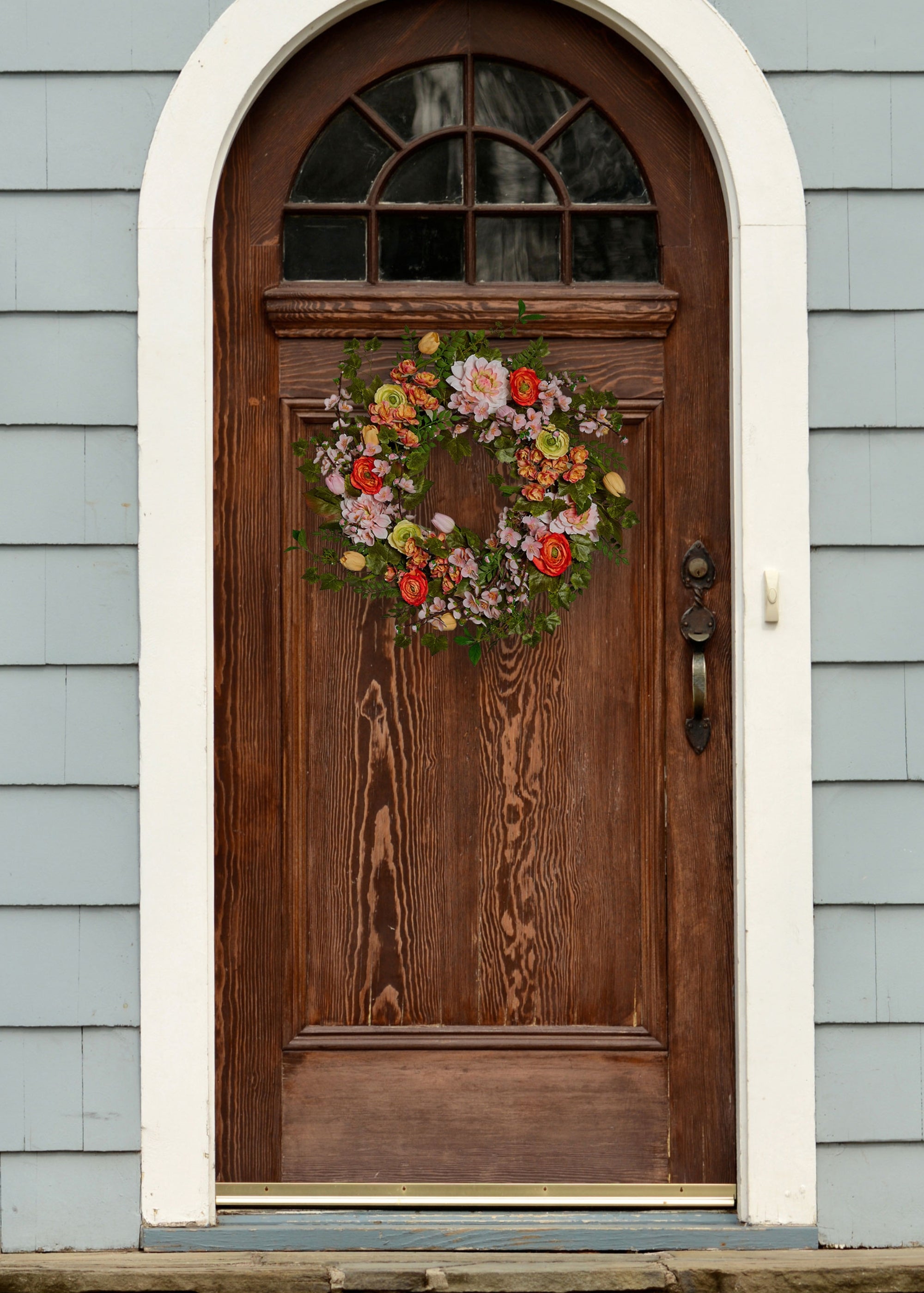 artificial garden flowers wreath on wood door