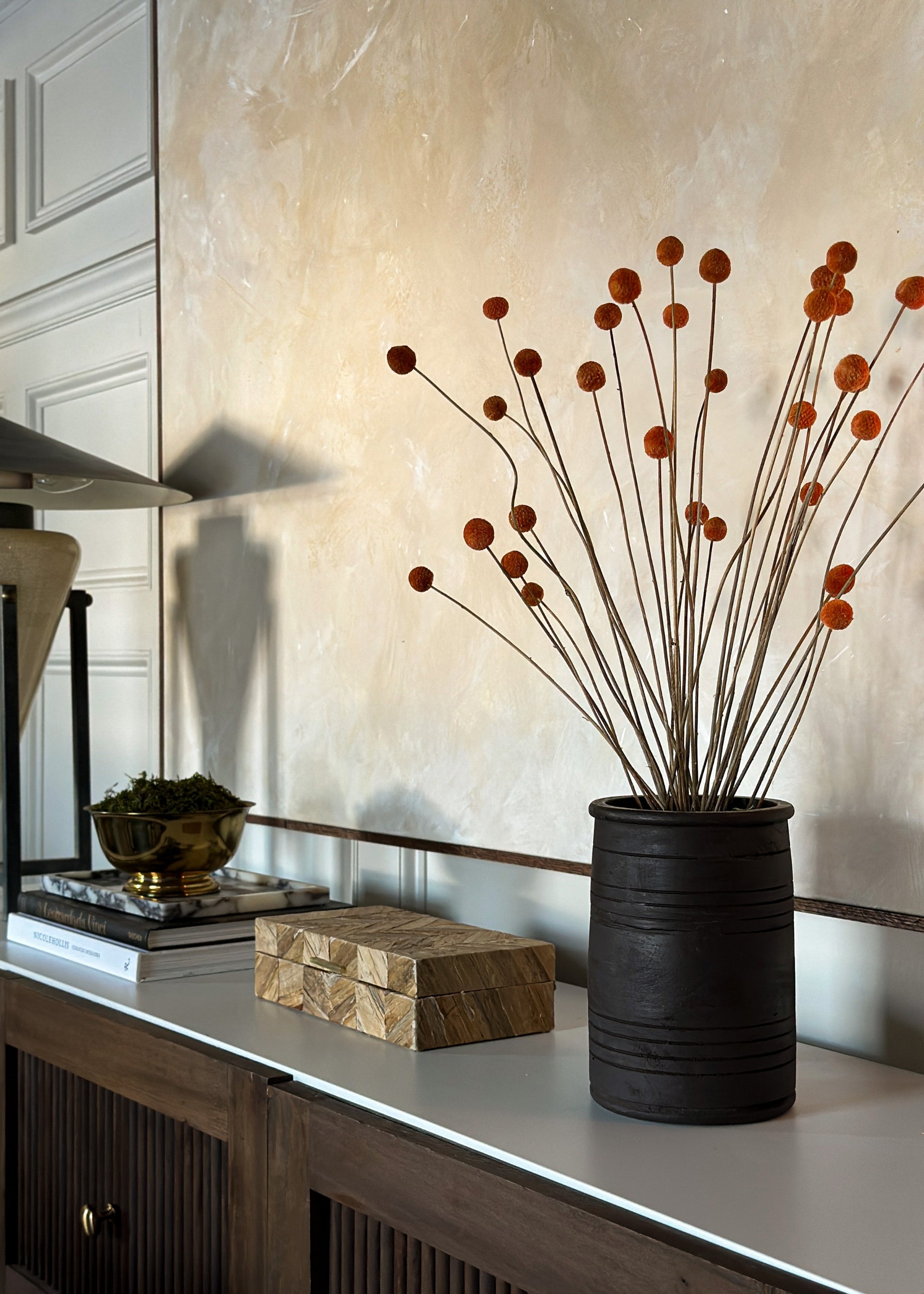 terracotta orange billy buttons styled in a vase