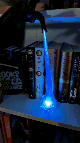 Fire-breathing dragon book nook light with illuminated flame effect