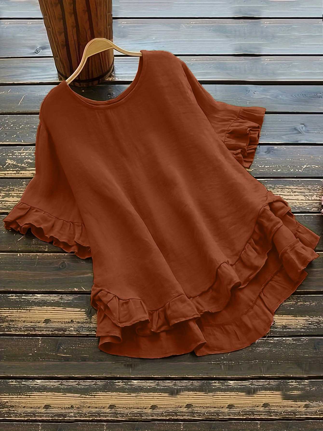 Buttonless ice silk ruffled hem top with front short and back long design, bell sleeves, and round neck
