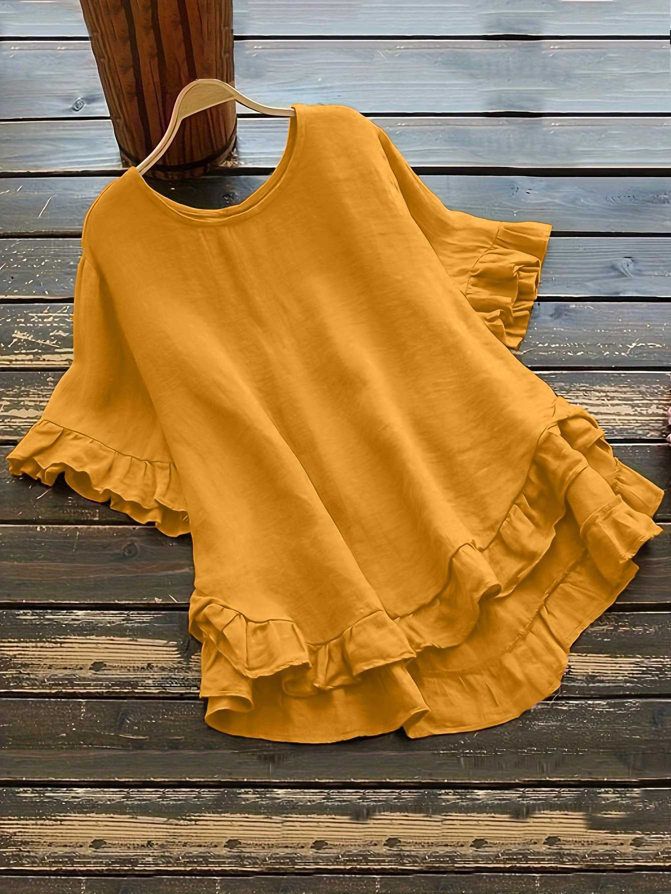 Buttonless ice silk ruffled hem top with front short and back long design, bell sleeves, and round neck