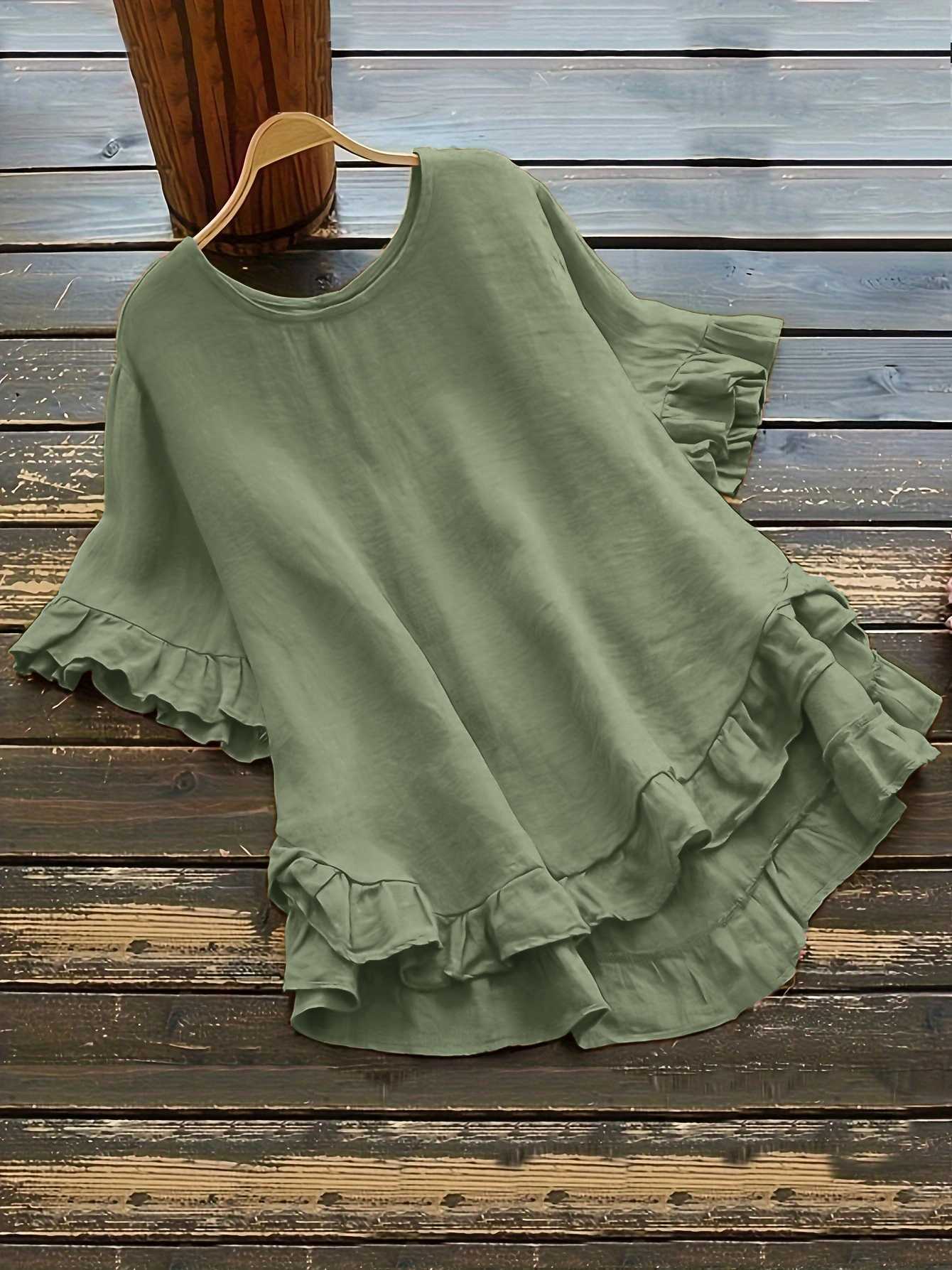 Buttonless ice silk ruffled hem top with front short and back long design, bell sleeves, and round neck