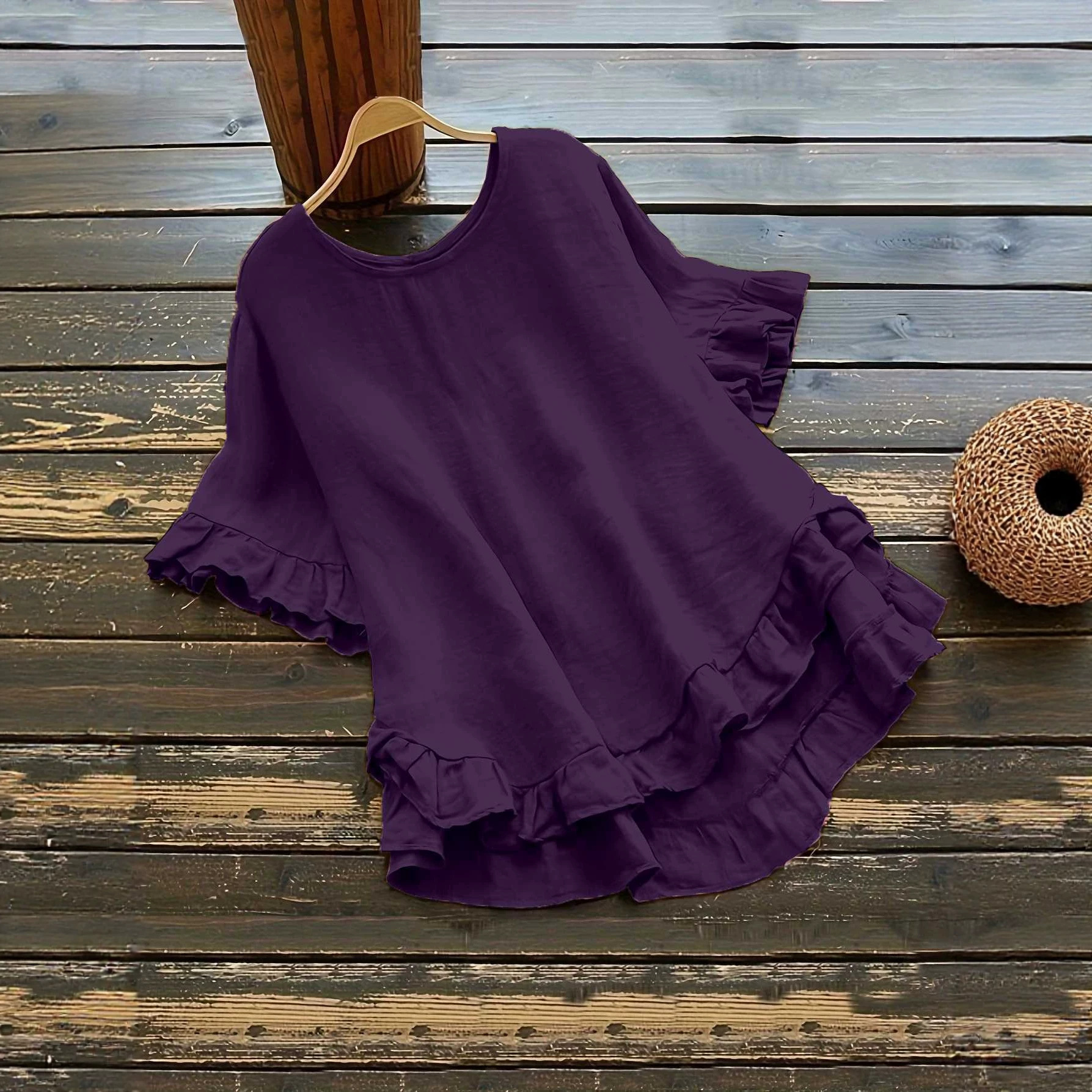 Buttonless ice silk ruffled hem top with front short and back long design, bell sleeves, and round neck