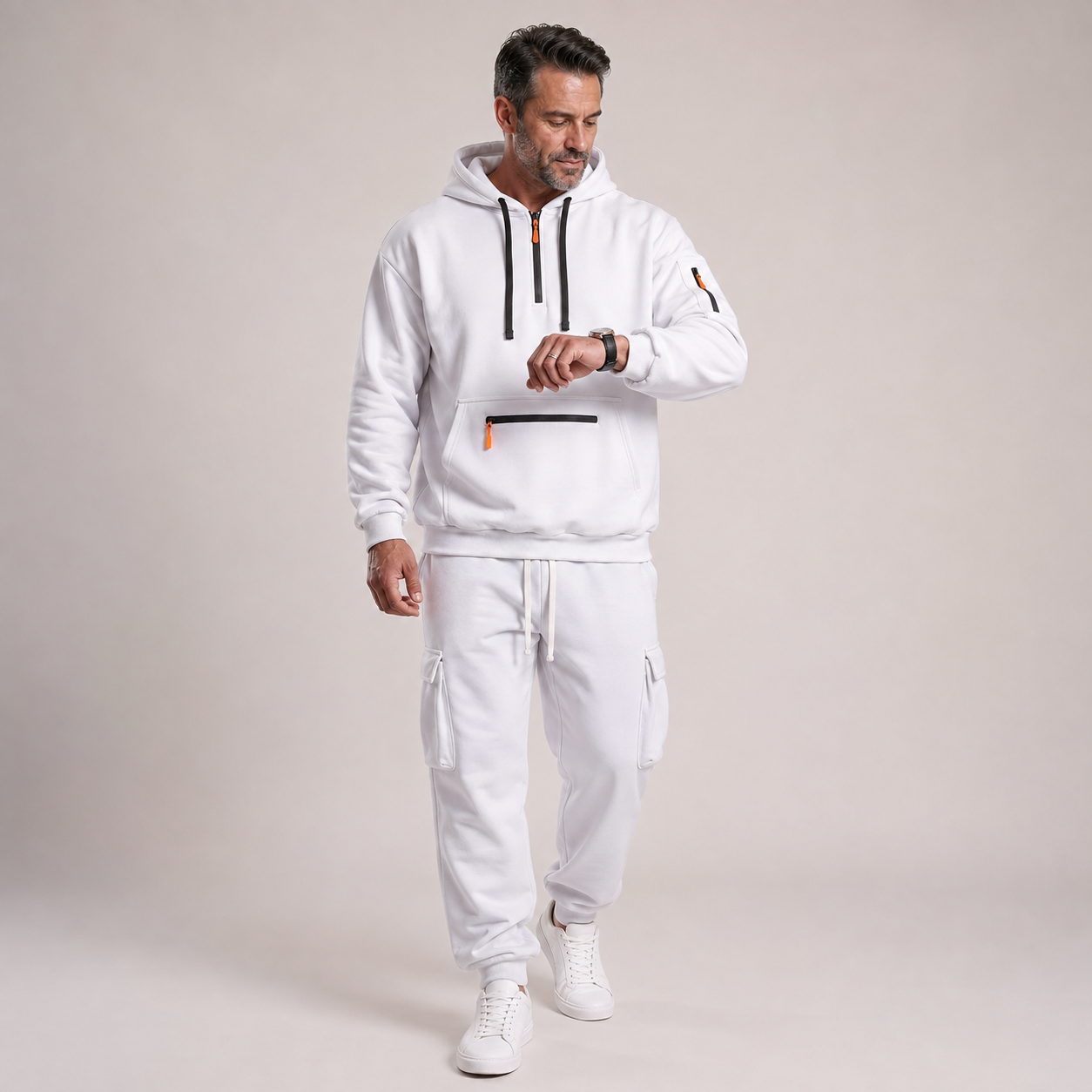 Mature male model wearing the white hooded quarter-zip cargo jogger 2-piece set, front view