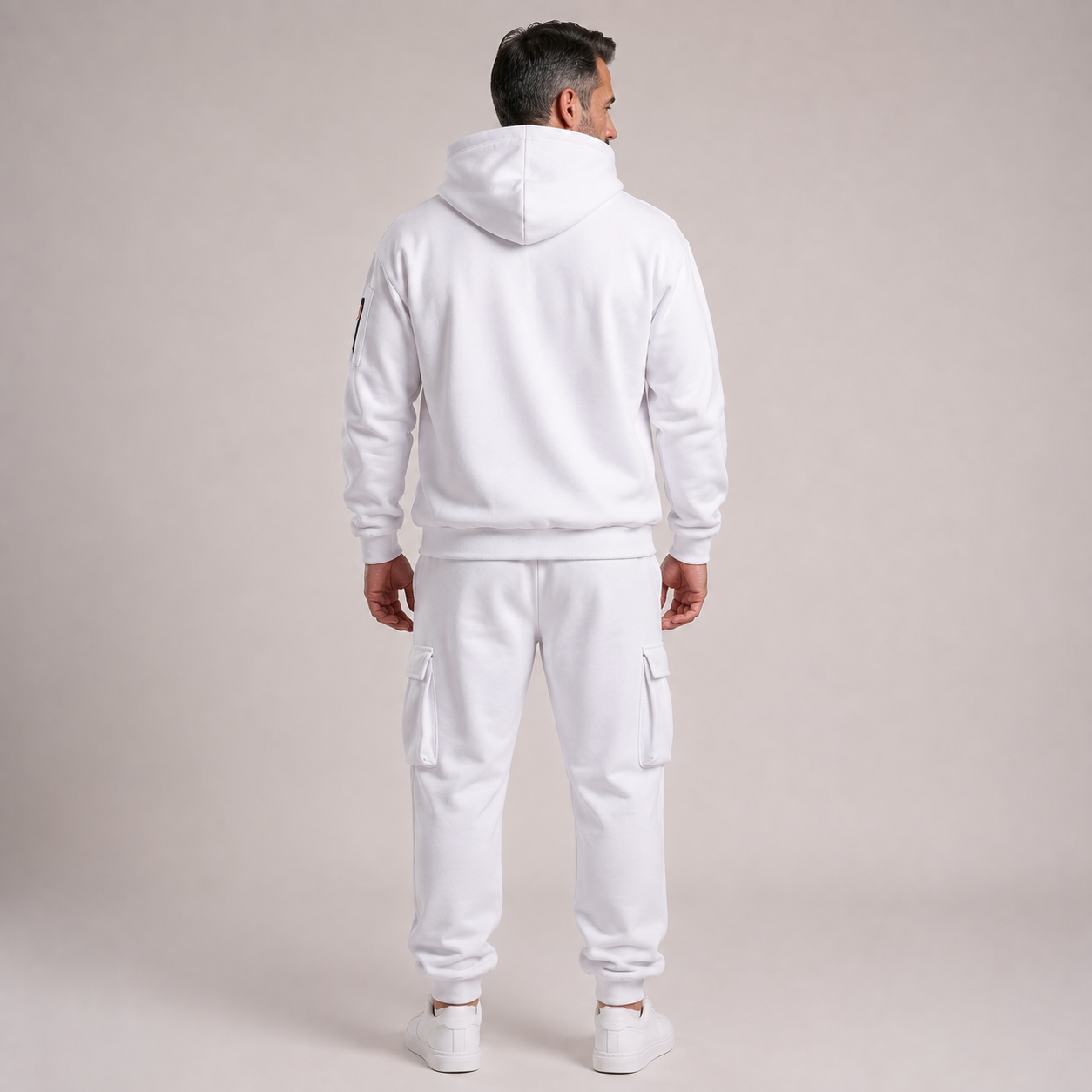 Mature male model wearing the white hooded cargo jogger 2-piece set, back view