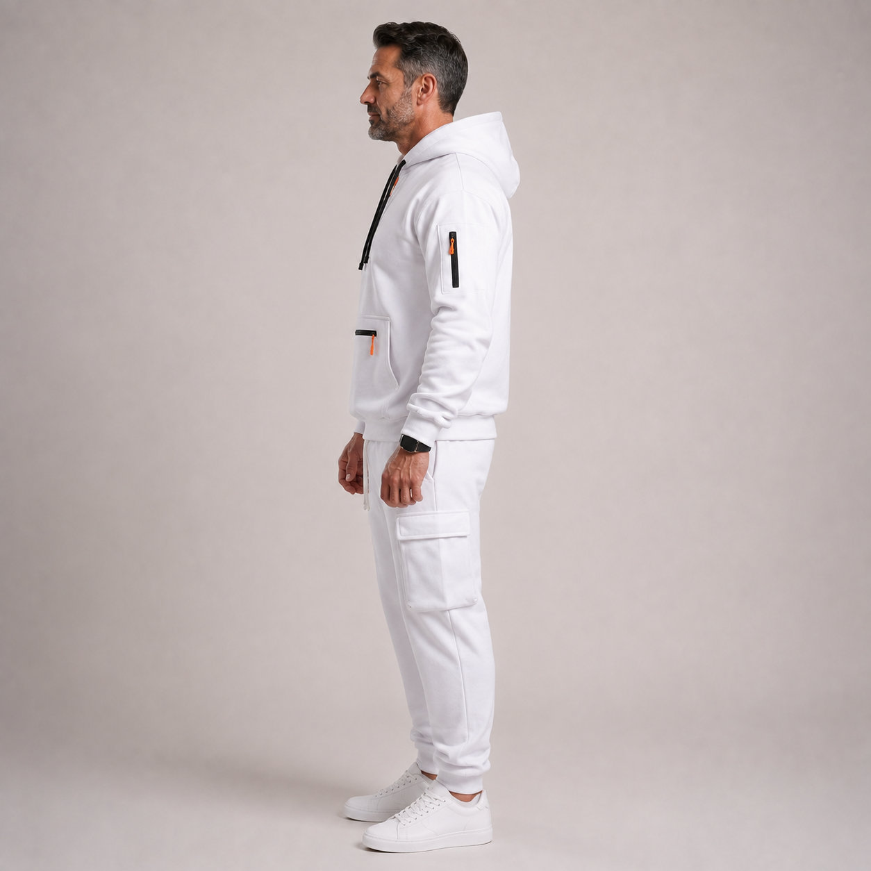 Mature male model wearing the white hooded cargo jogger 2-piece set, left-side view