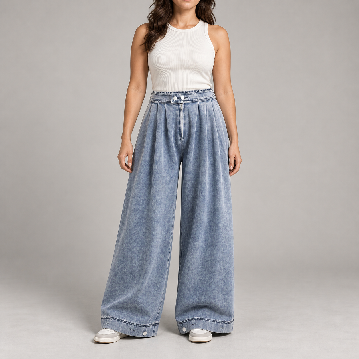 Front view of a woman wearing blue high-waist pleated balloon jeans with double-snap tab and zip fly
