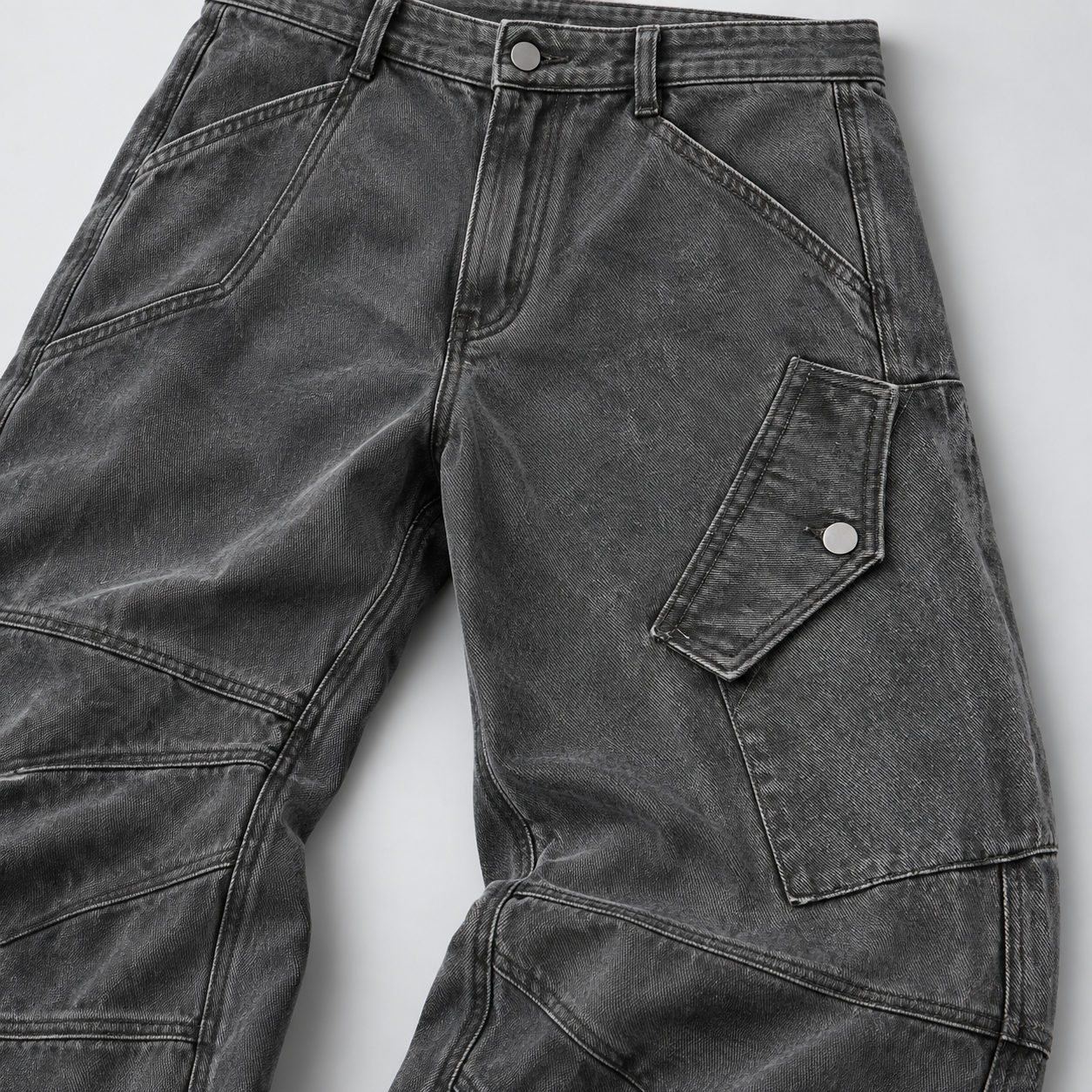 Close-up of washed cotton twill, snap-tab cargo pocket and panelled knee seams