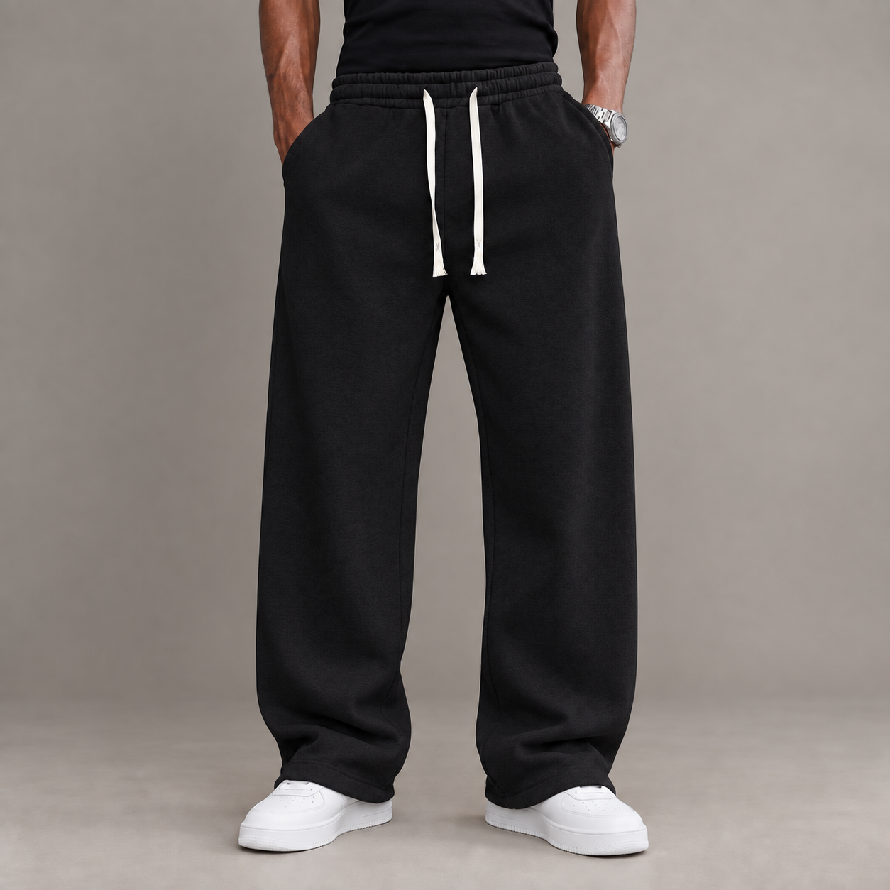 Adult male model wearing the Black unisex relaxed straight-leg casual pants