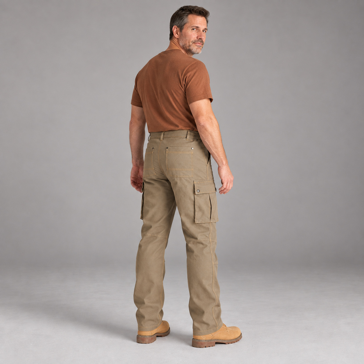 Three-quarter back view of an adult male wearing Tarmac Grey cargo work pants