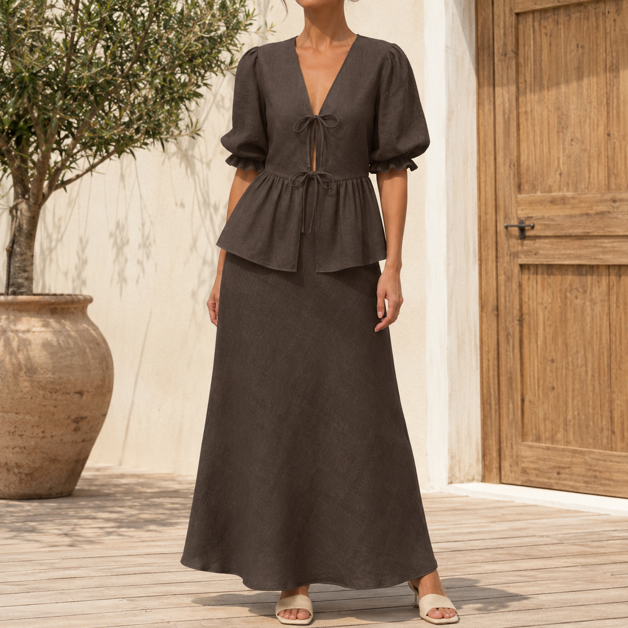 Front view of mocha brown tie front puff sleeve top and maxi skirt