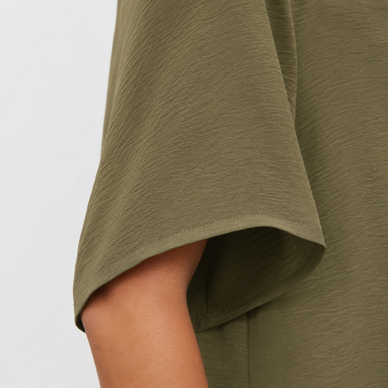 Half sleeve and fabric detail on loose-fit blouse