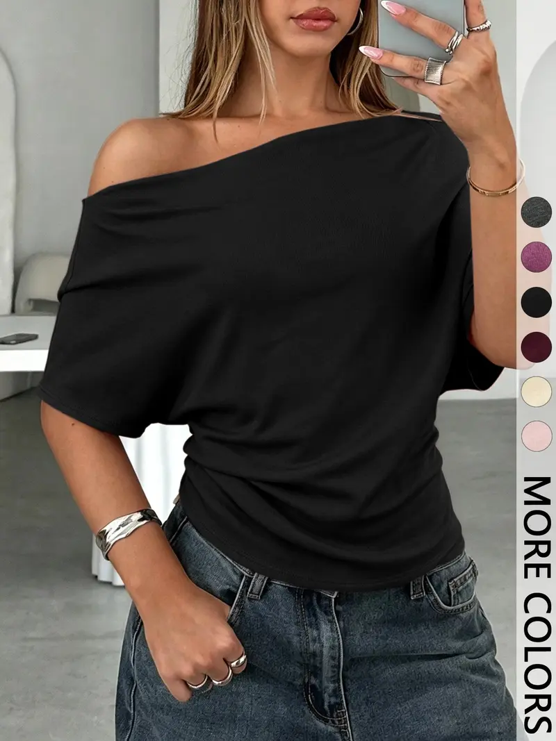 Black off-shoulder draped batwing top front view
